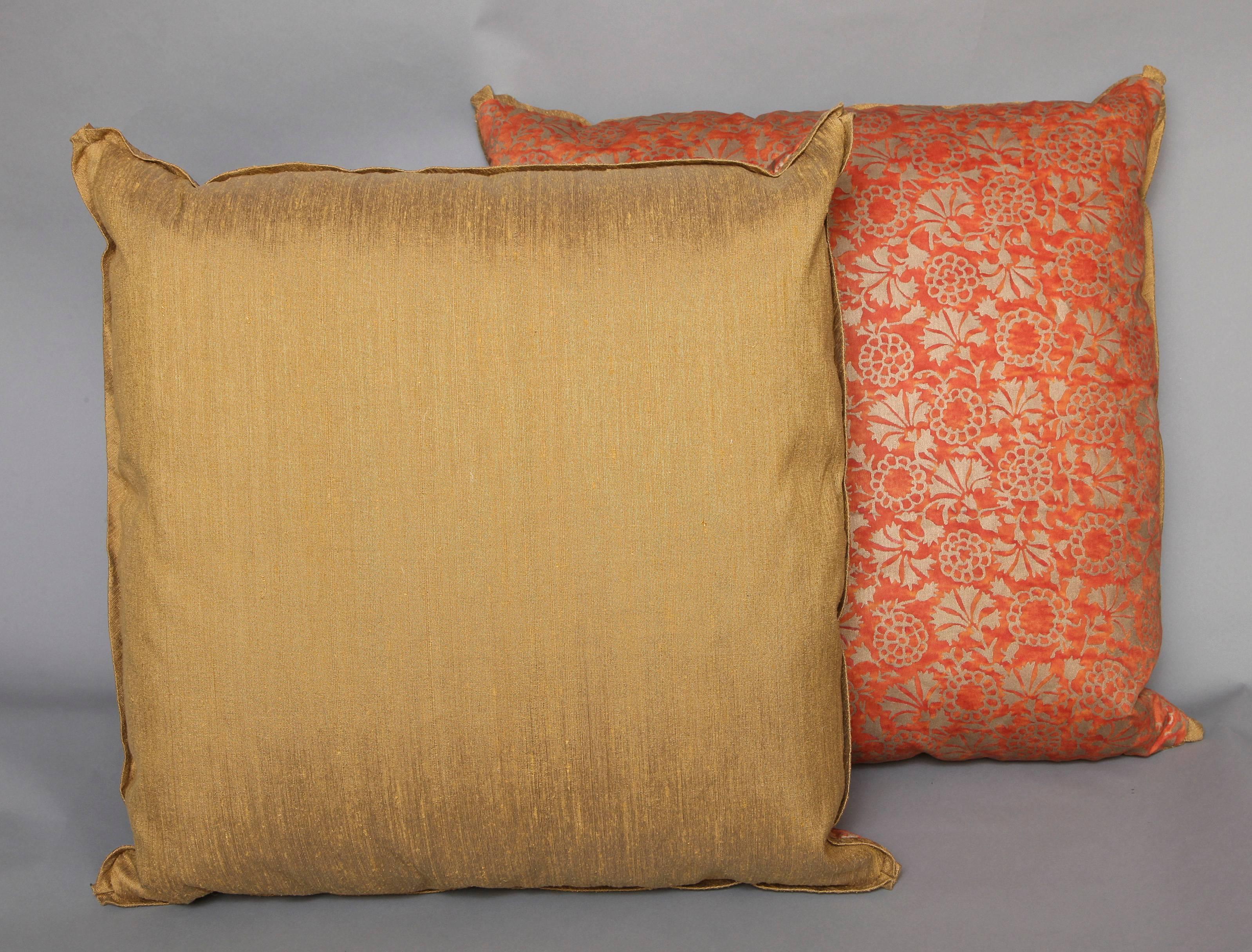 A pair of Fortuny fabric cushions in the Irani pattern, poppy colored with gold thai silk backing and matching silk bias edging, the pattern, a 17th century Persian design 
50 down/50 feather insert
Newly made using vintage Fortuny fabric, circa