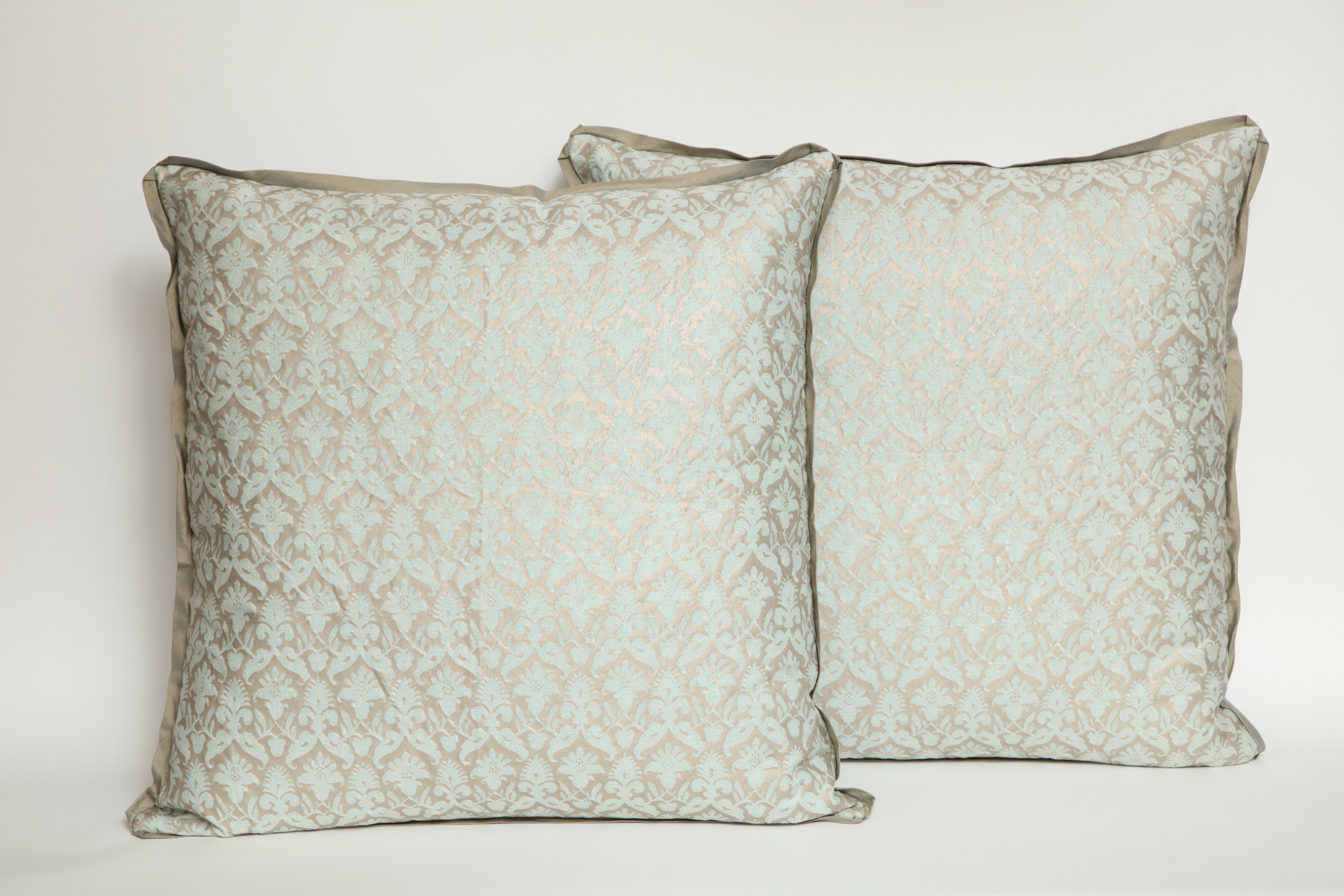 A pair of Fortuny fabric cushions in the Delfino pattern, aquamarine and silver color way with silk bias edging, the pattern, a 17th century French design in the Louis XIII style. Newly made using vintage Fortuny fabric. 50 down/50 feather insert.