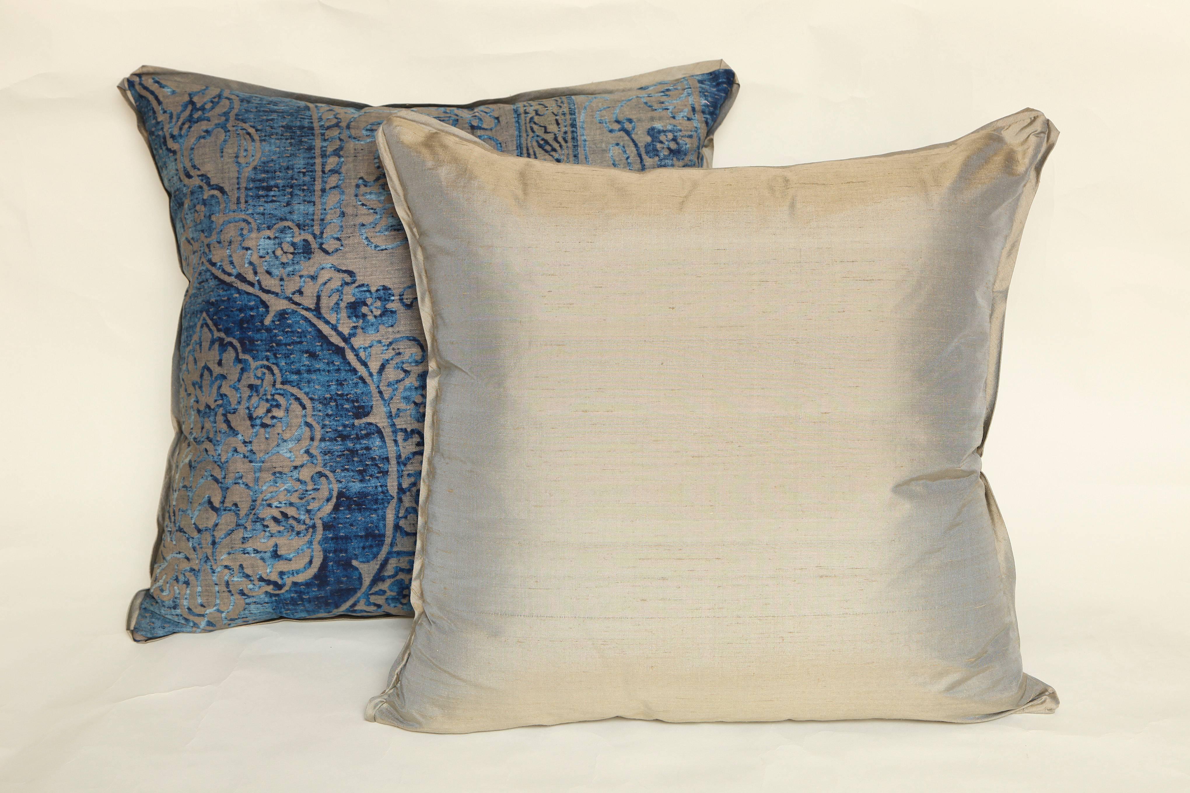 A pair of Fortuny fabric cushions in the Nicolo pattern, indigo on silver metallic ground, silk bias edging with silk blend backing material, the pattern, a Moorish style design with artichoke motif. Newly made using early 20th century Fortuny