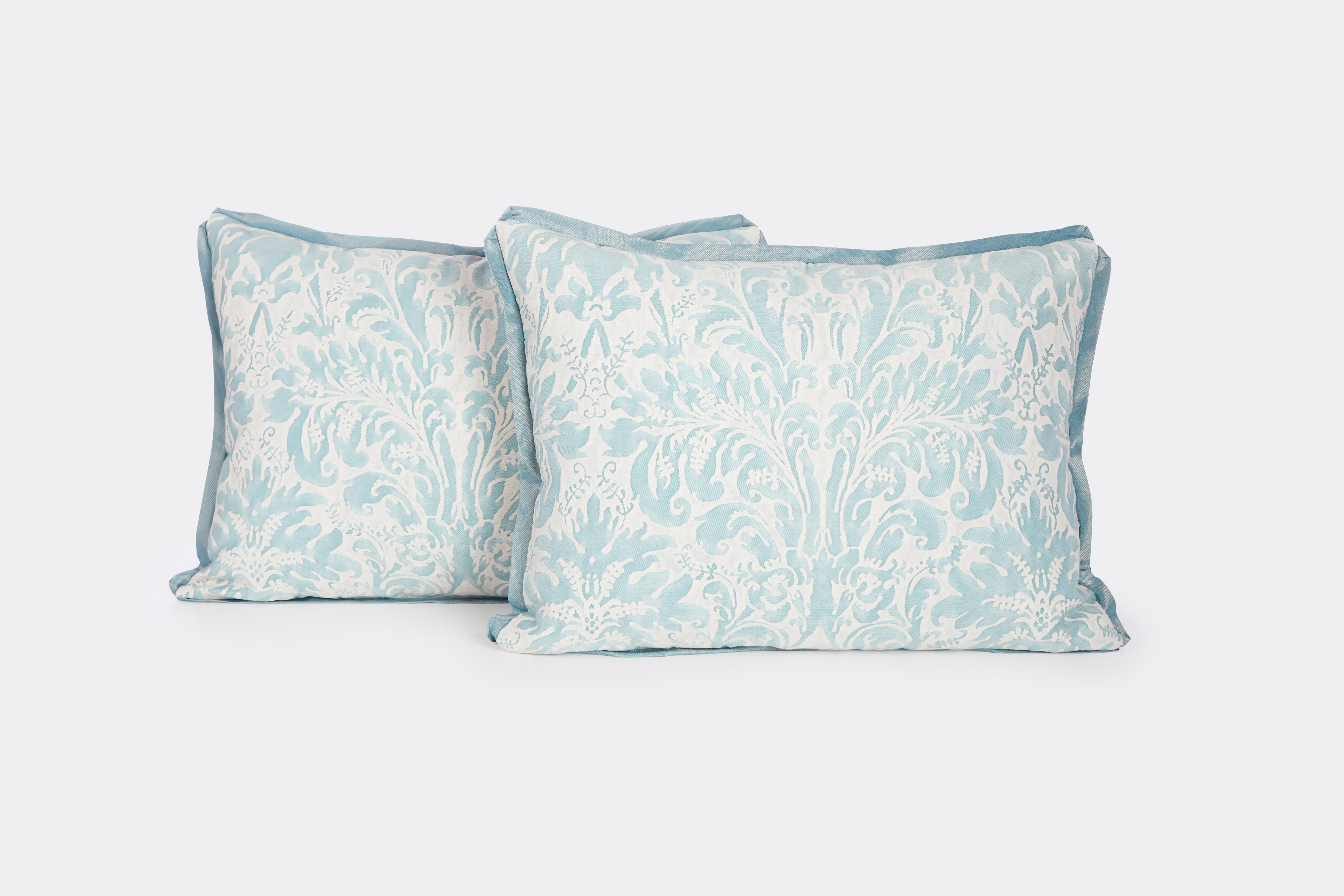 A pair of Fortuny Sevigne cushions in French blue and antique white with blue bias silk edging and white self striped backs. Made by David Duncan Studio in New York City.