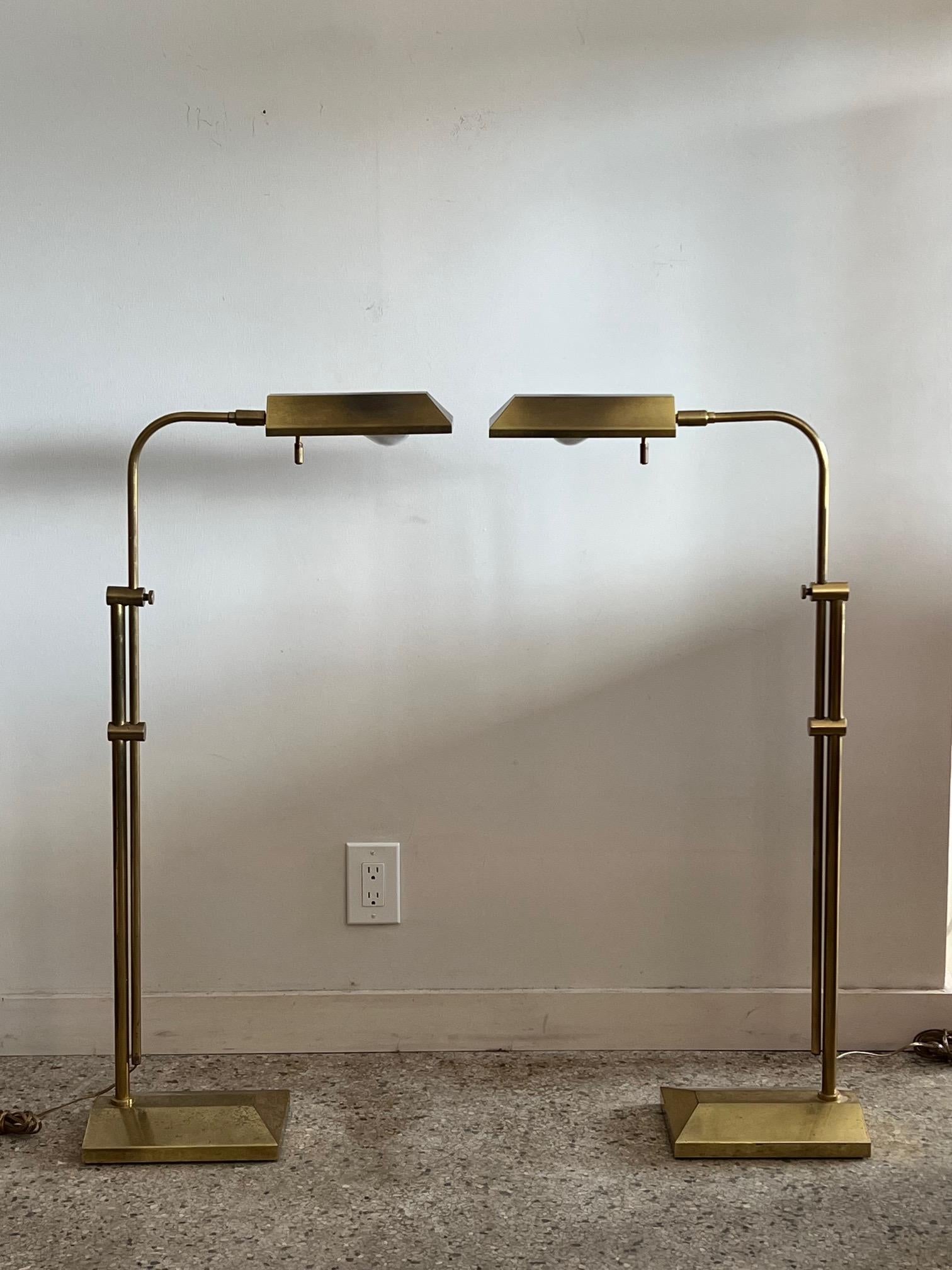 A pair of Frederick Cooper, Chicago brass reading lamps. Height adjustable from 39.5