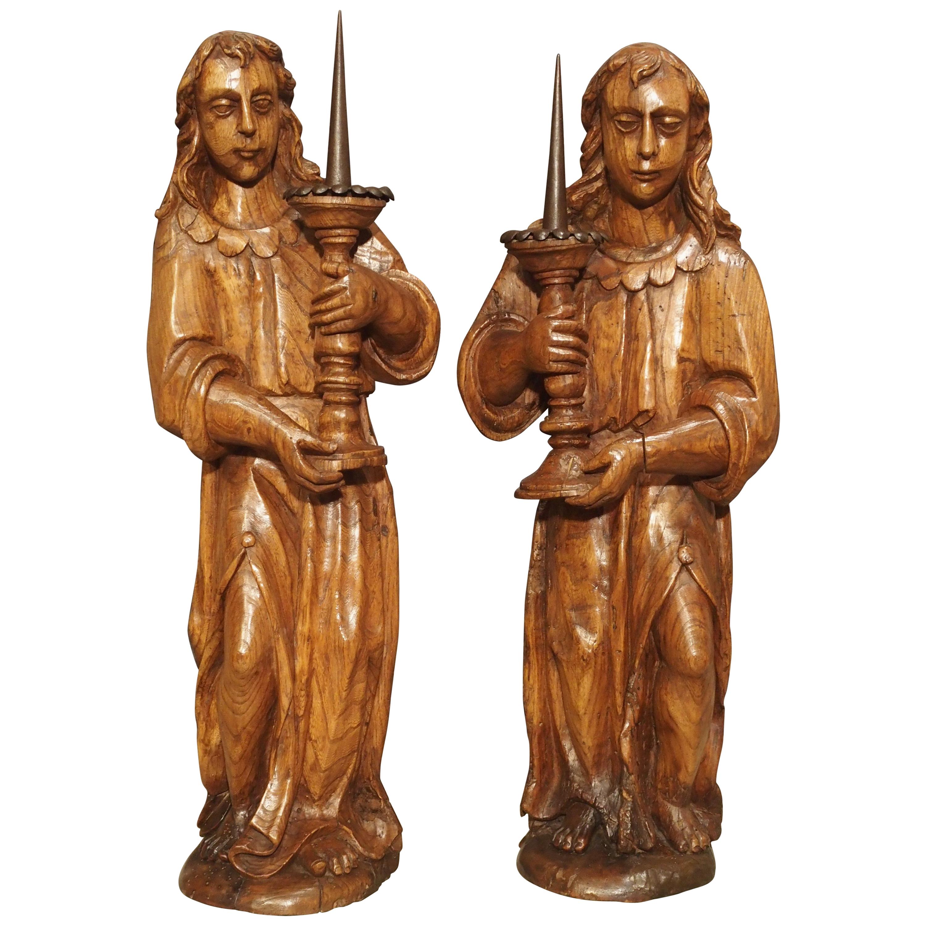 Paire de porte-bougies d'anges français du XVIIe siècle en bois d'orme sculpté