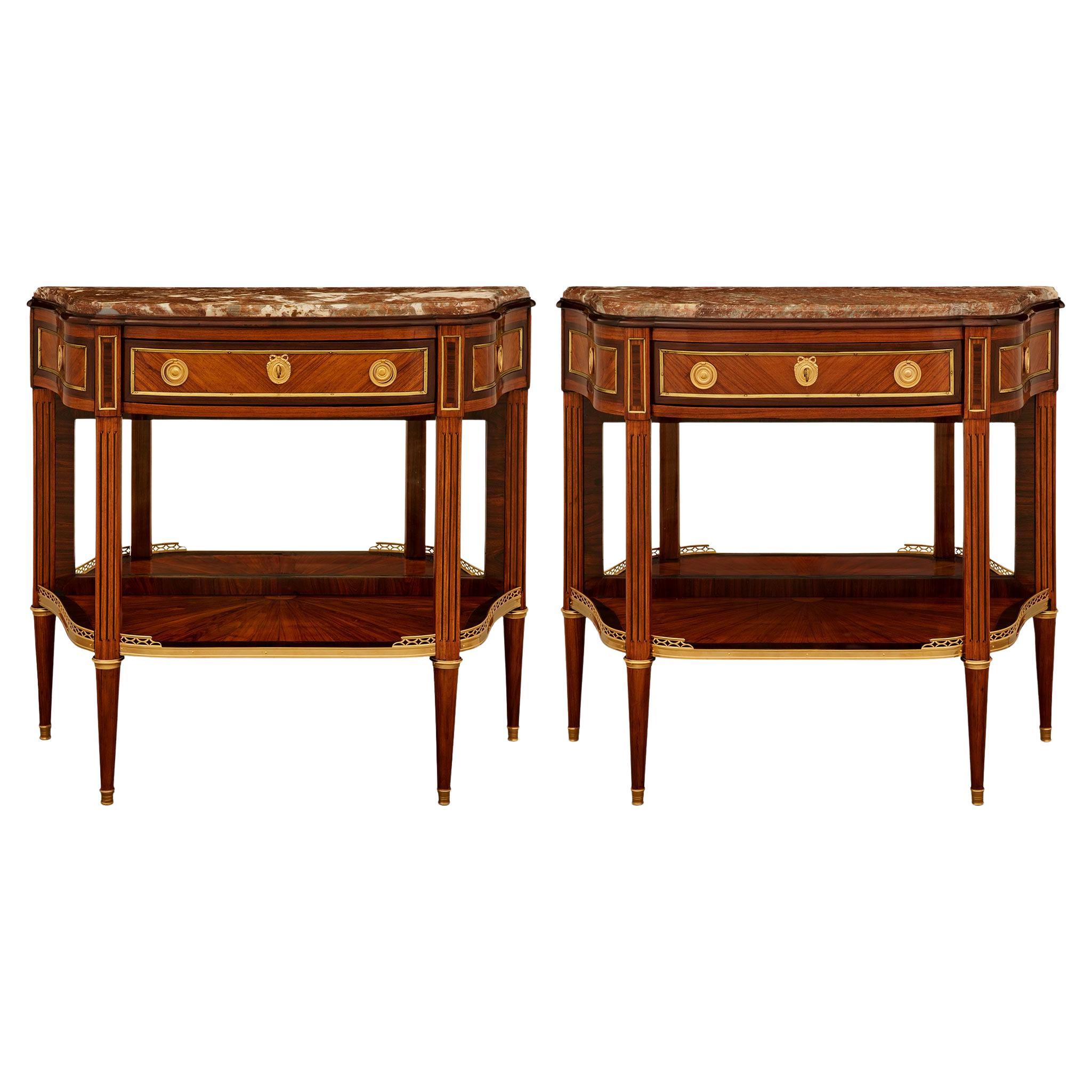 A pair of French 18th century Tulipwood, Kingwood, Ormolu and marble consoles