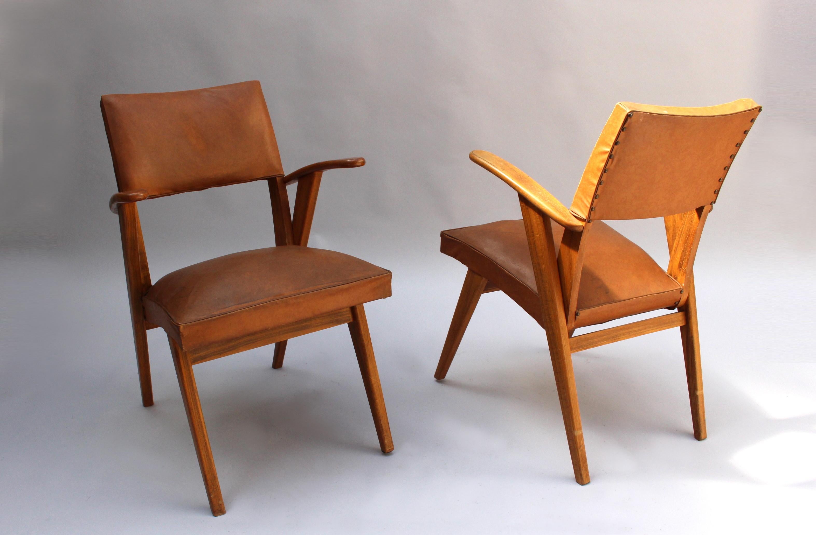 A pair of French midcentury beech compass style bridge / desk armchairs.