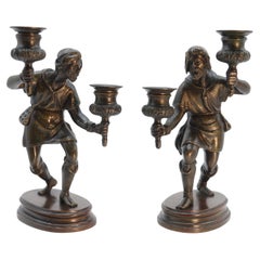 A pair of French 19th century bronze figurative double candlesticks circa 1860