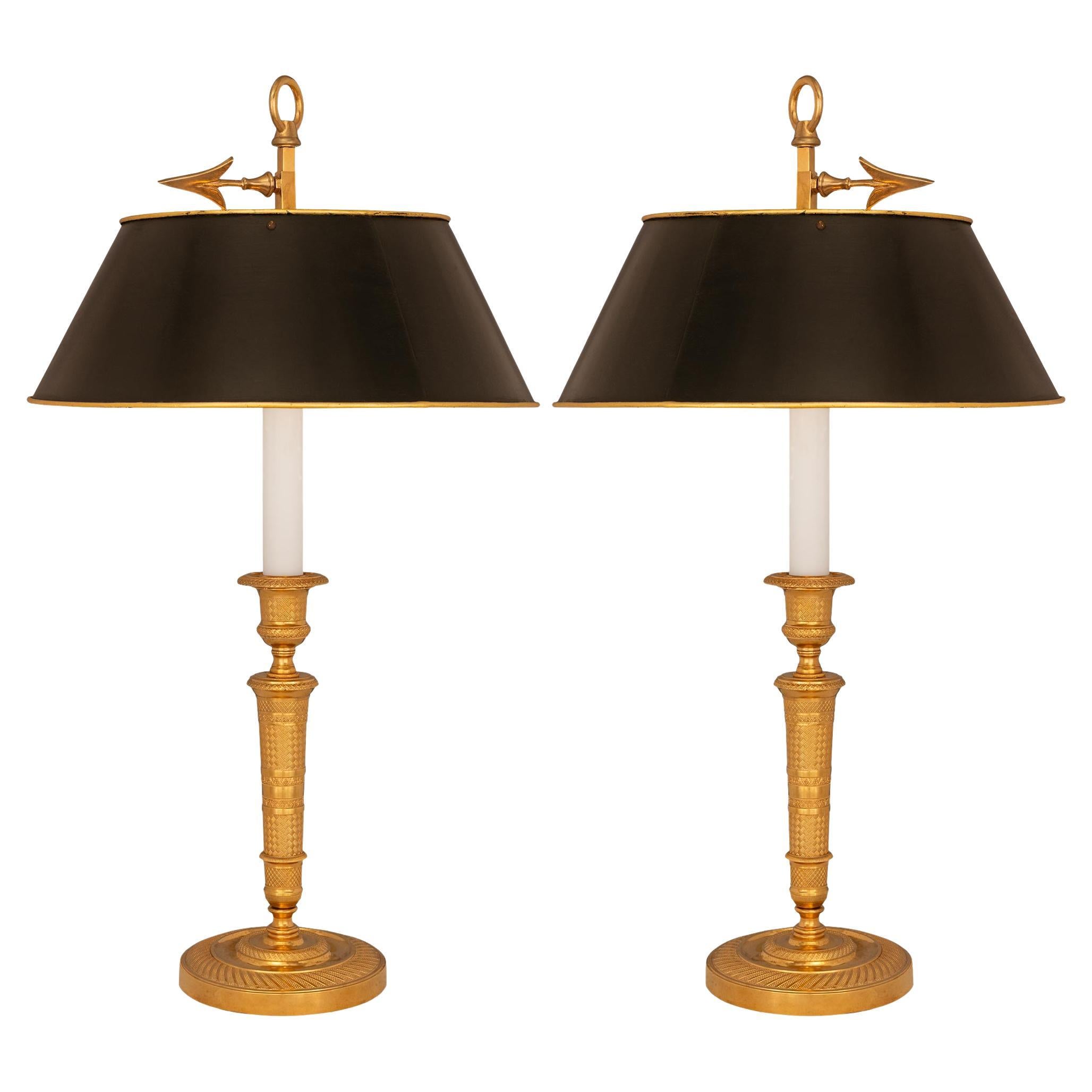 A pair of French 19th century Charles X st. candlestick lamps