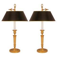A pair of French 19th century Charles X st. candlestick lamps