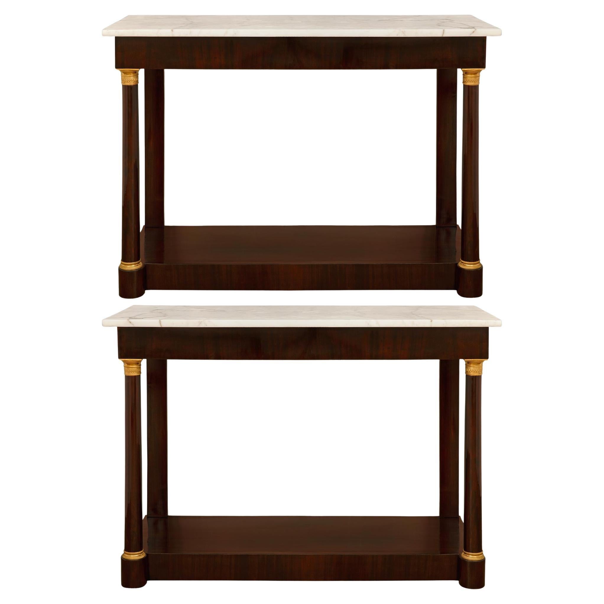 A pair of French 19th century Mahogany, Ormolu and white Carrara marble consoles For Sale