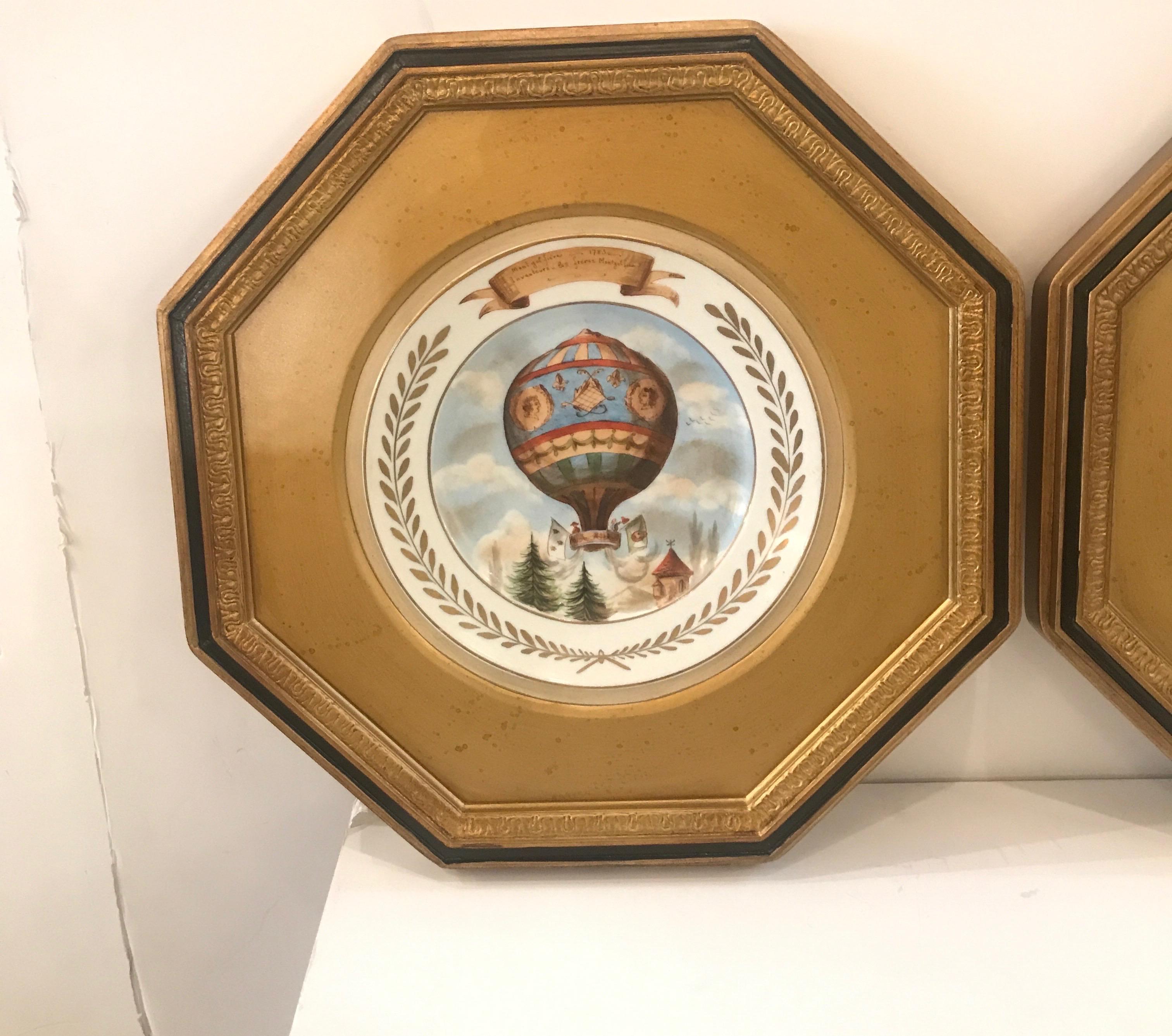 Whimsical hand painted porcelain plates of old time French hot air balloons. The old pairs porcelain plates circa 1880s with a mid-20th century octagonal gilt frames with a black accent on the outer frame. Beautifully painted and in excellent