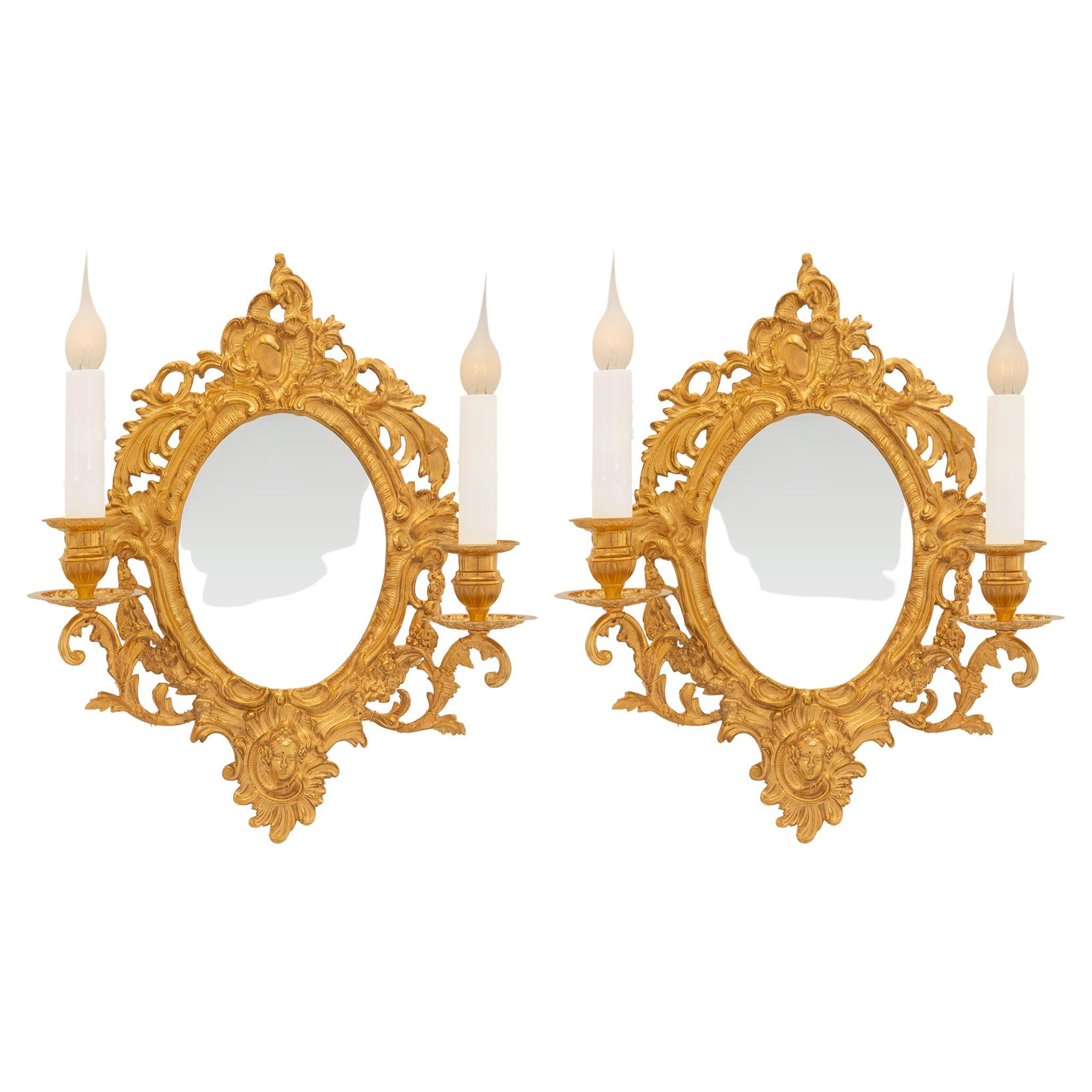 A pair of French 19th century Louis XV st. Ormolu mirrored sconces For Sale