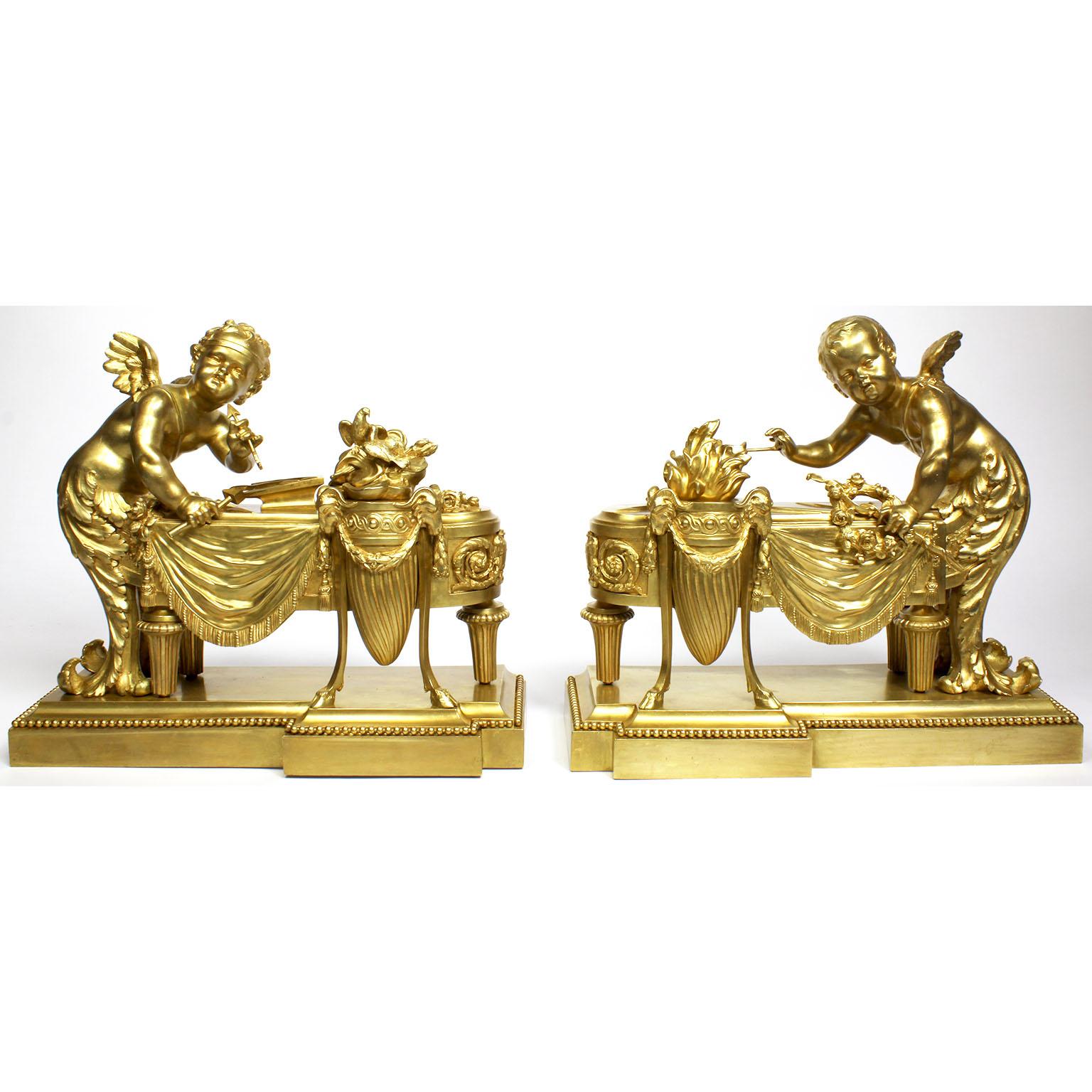 A very fine and charming pair of French 19th-20th century Louis XV style Belle Époque figural gilt-bronze chenets. The finely chased whimsical ormolu andirons, each surmounted with a figure of a standing cupid or cherub, both angel blacksmiths