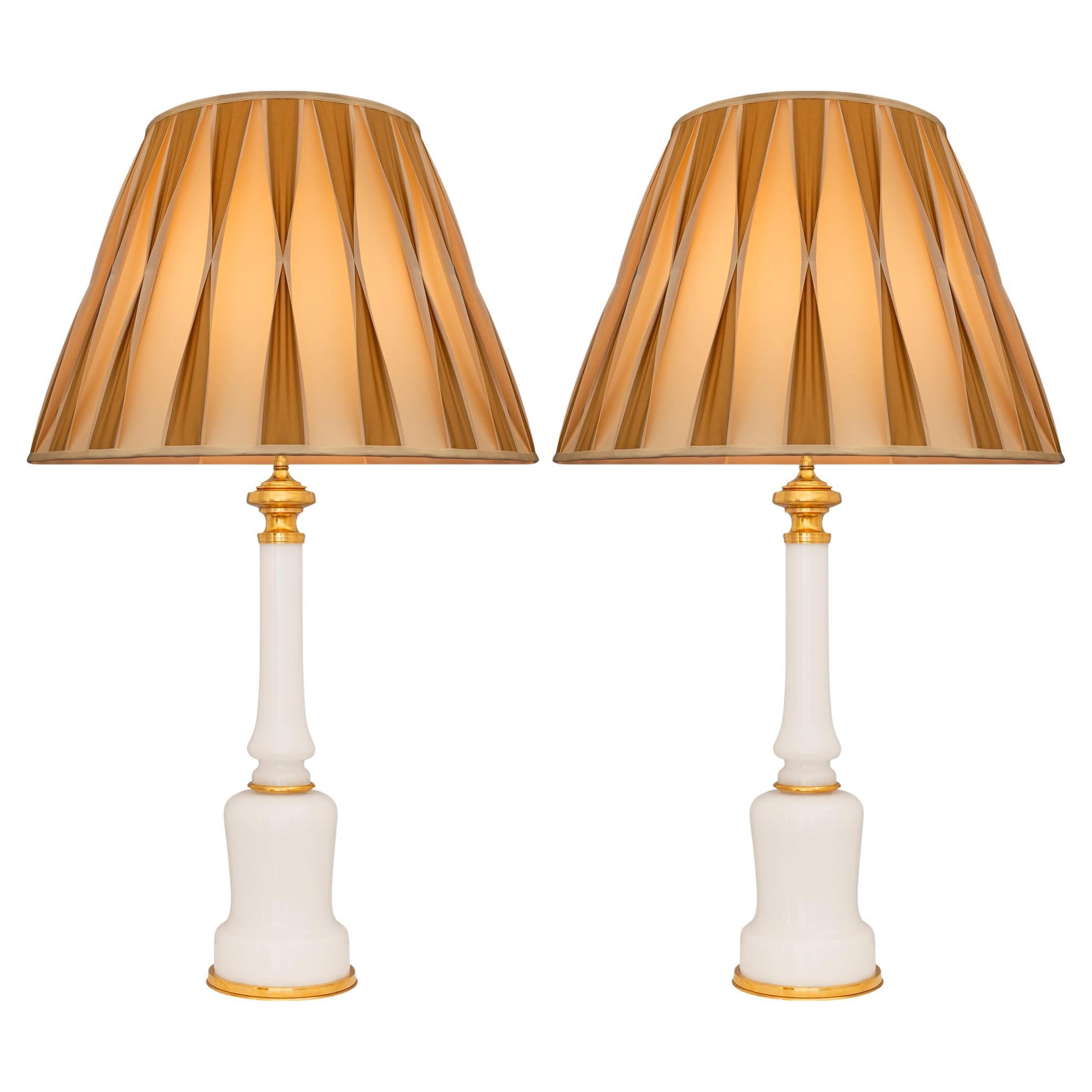 A pair of French 19th century Louis XVI st. Opaline Glass and Ormolu lamps