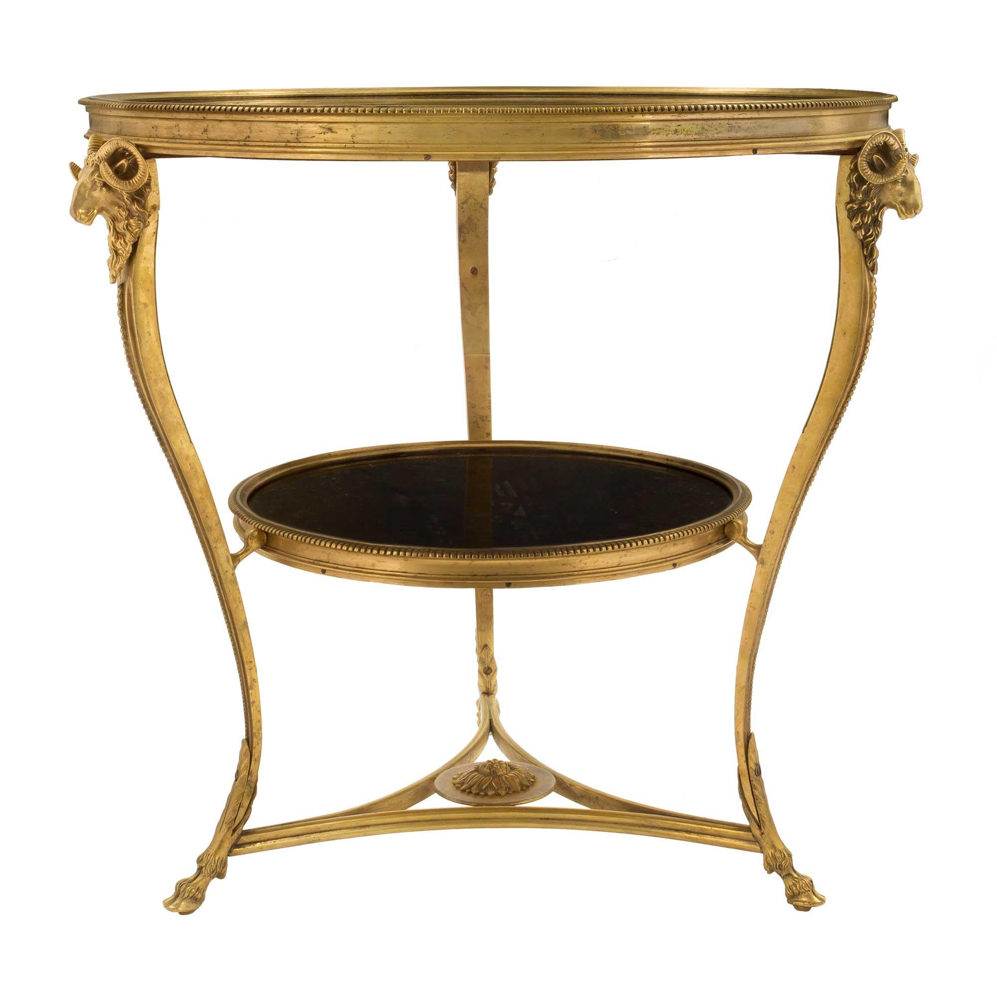 A most elegant and high quality pair of French 19th century Louis XVI style ormolu and black Belgium marble Guéridons. Each side table is raised by handsome and detailed hoof feet adorned with large acanthus leaves joined by a triangular stretcher