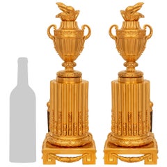 A pair of French 19th century Louis XVI st. Ormolu and Iron Chenet/andirons