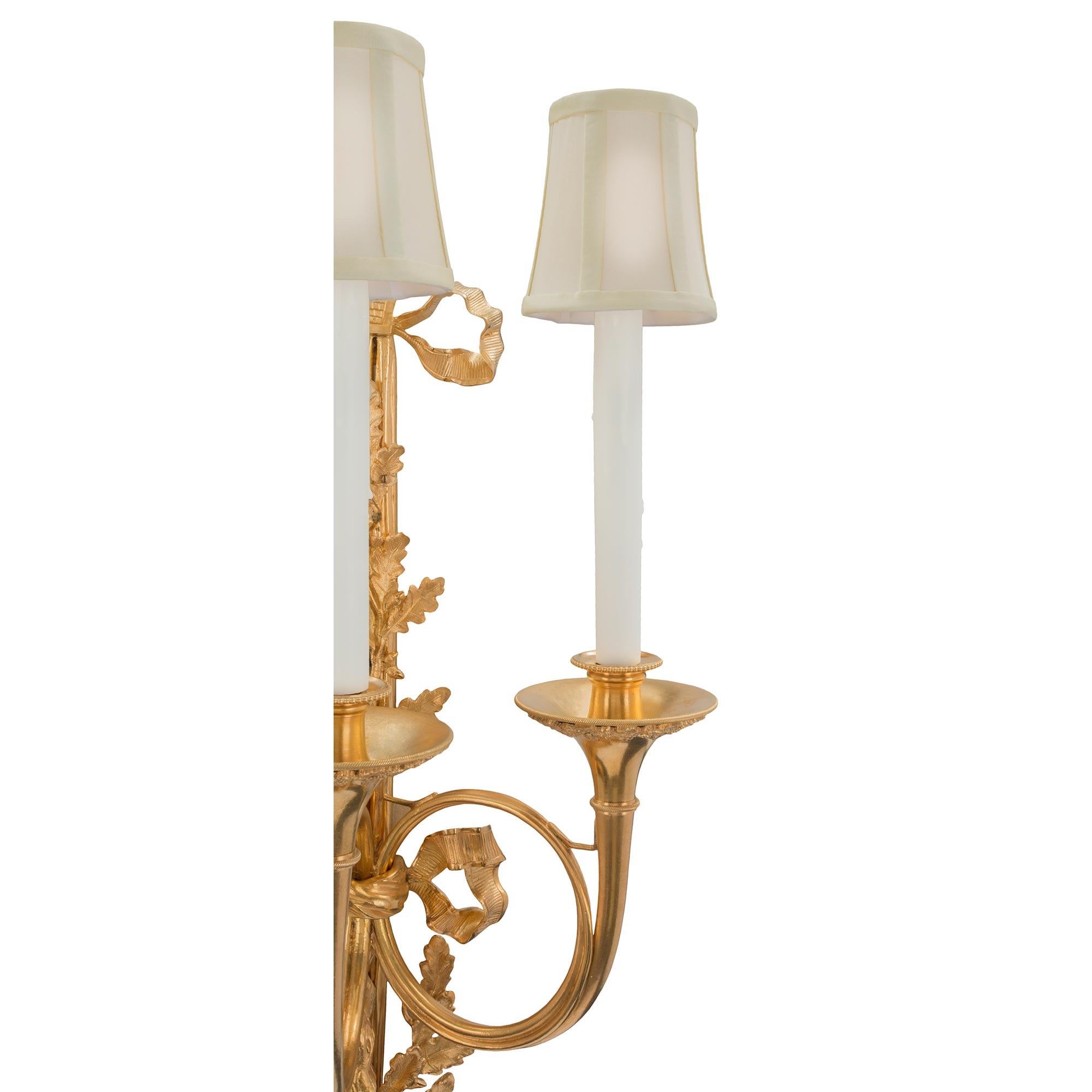 A pair of French 19th Century Louis XVI st. ormolu three arm sconces 2