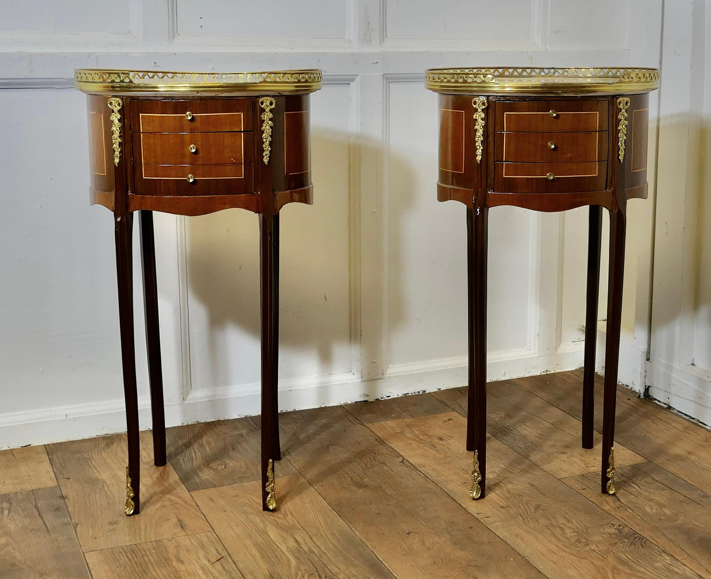 A Pair of French 19th Century Oval Side Tables or Bedside Cabinets  

This is a superb quality pair of French side tables, they have a pierced brass gallery around the top and they each have 3 small drawers to the front with ormolu mounts on the