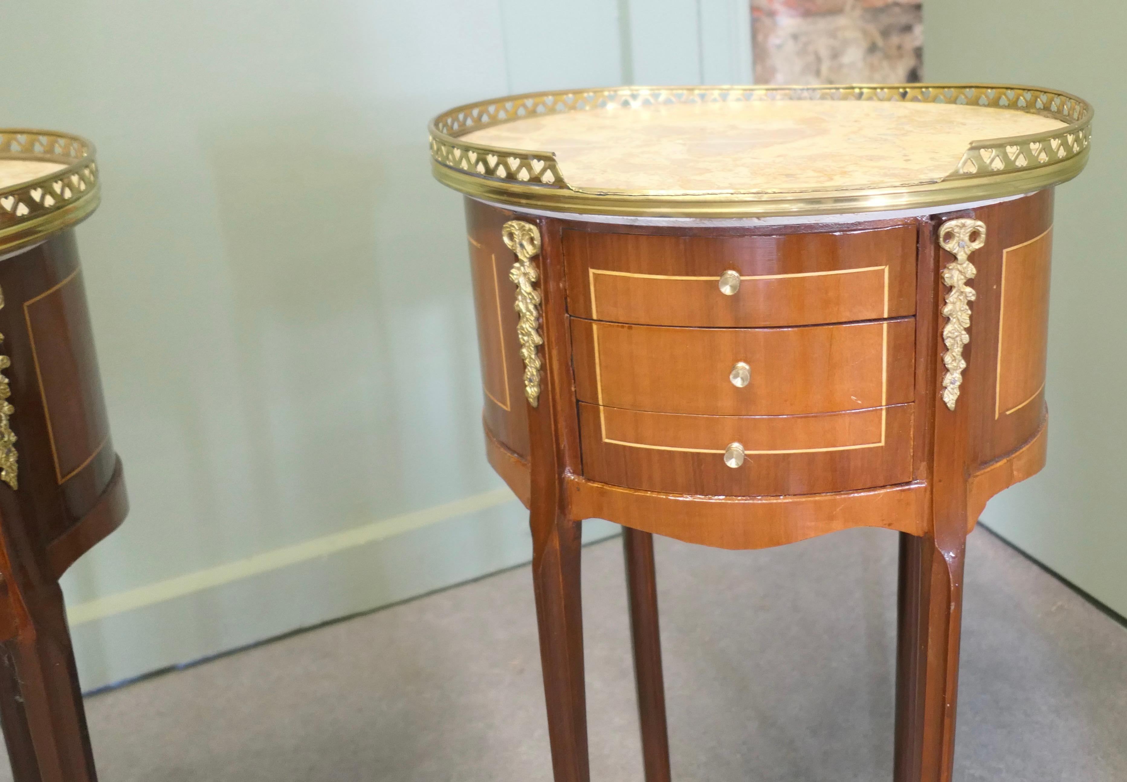 A Pair of French 19th Century Oval Side Tables or Bedside Cabinets  

This is a good pair of French bedside tables, they have a pierced brass gallery around the top and they each have 3 small drawers to the front with ormolu mounts on the feet and