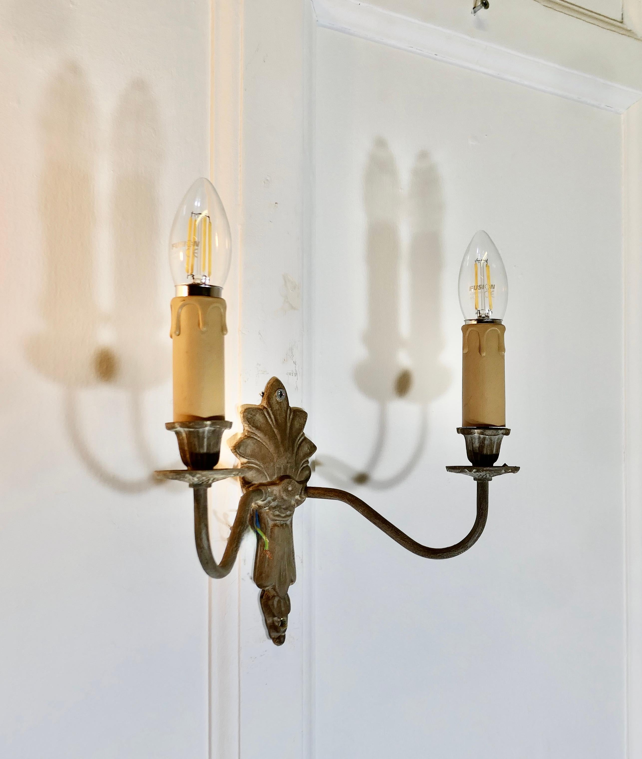 A pair of French 4 Neo Classical Metal Twin Wall Lights


The lights are in the classical style, they have bronzed metal finish
Each light has 2 branches each with a sconce and candle tube
The Lights are working, they will need to be connecter to an