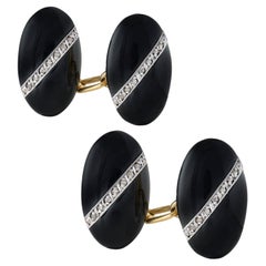 A pair of French Art Deco onyx and diamond cufflinks