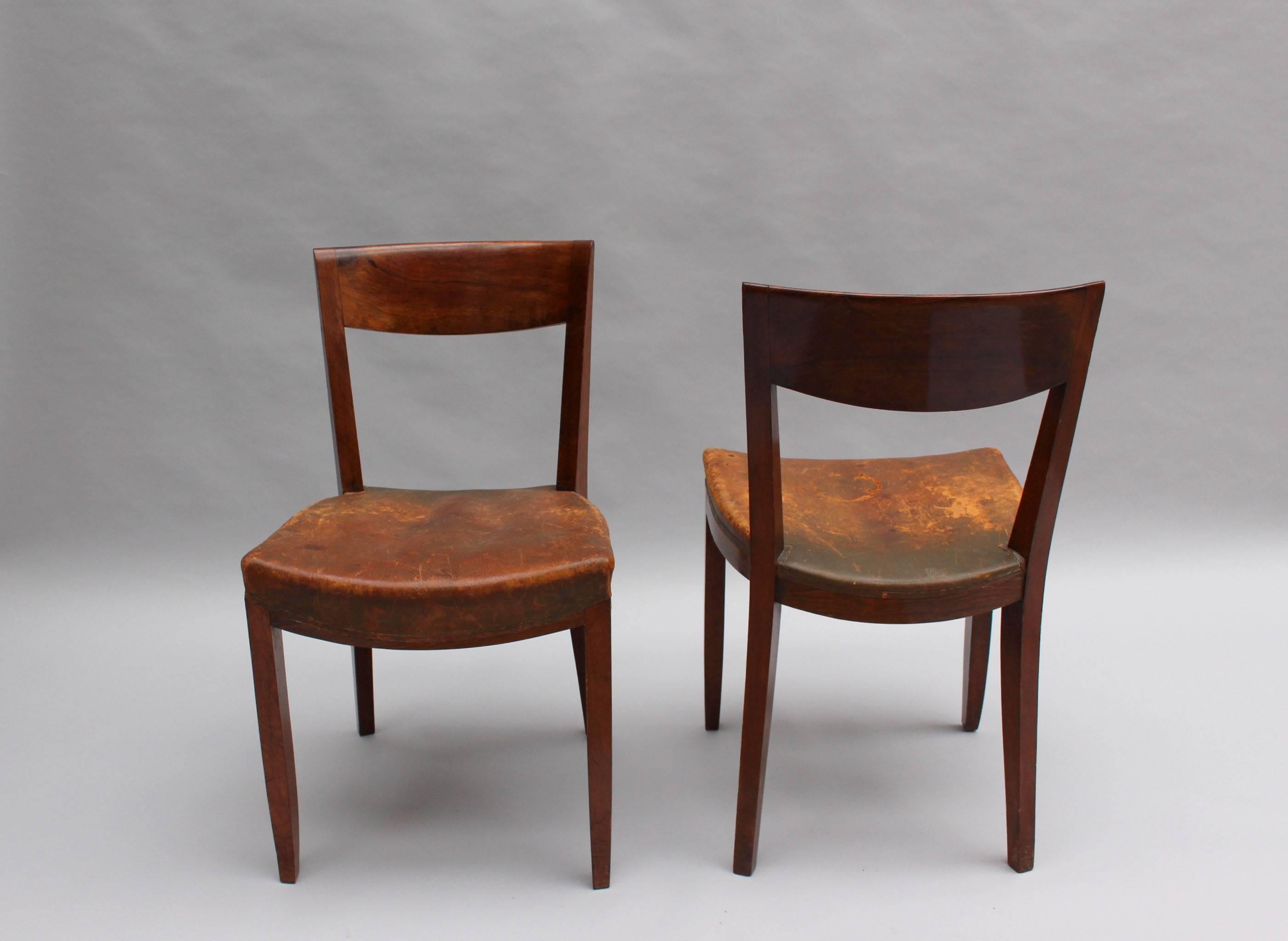 A pair of French Art Deco rosewood dining or side chairs by Jules Leleu.