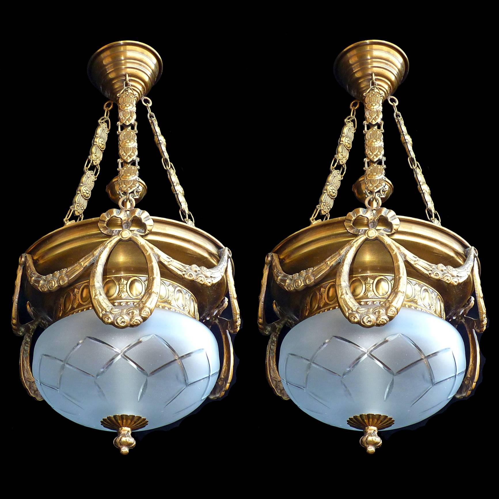 A pair of vintage brass French Art Deco/Art Nouveau gold and bronze color cut-glass chandeliers

Measures: Diameter 11 inches / 27 cm
Height 24 inches / 60 cm 
Weight: 10 lb. (4 kg)
Two bulbs (five bulbs each/ E14 
Good working condition /