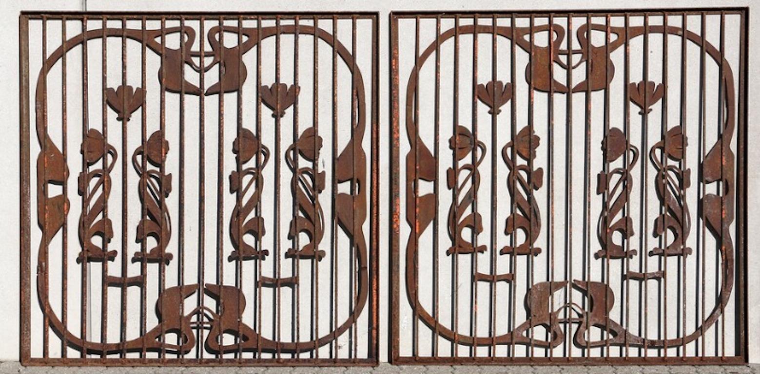 A pair of French Art Nouveau wrought iron garden gates; partially painted. With foliaged and tulip motif, painted in shades of rust rose and teal, early 20th century.