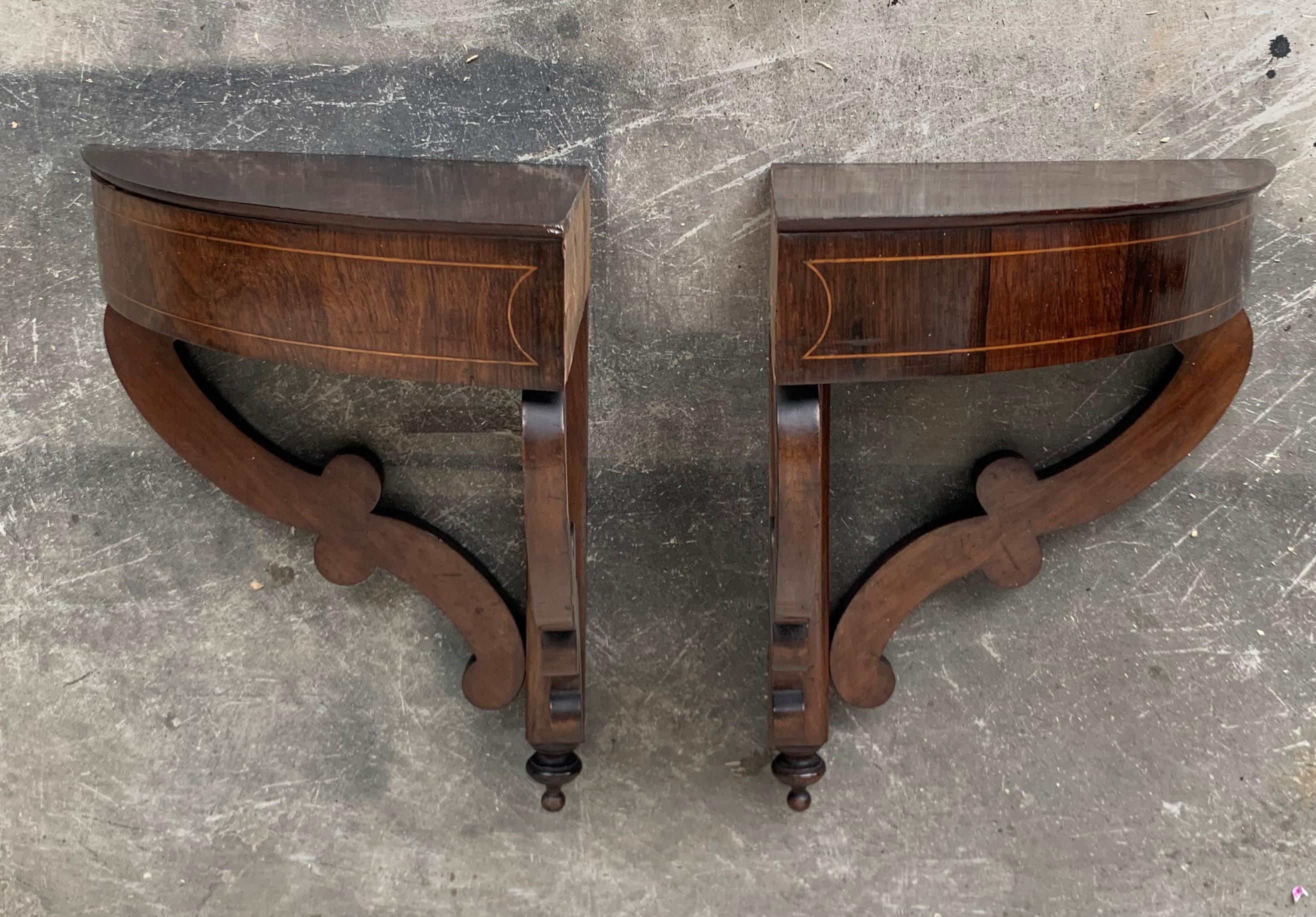 A handsome pair of Biedermeier consoles. Each wall-mounted console is raised by fine block feet below scrolled movements.
Above are the original walnut tops which follows the contour of the console with rounded corners and an exceptional double