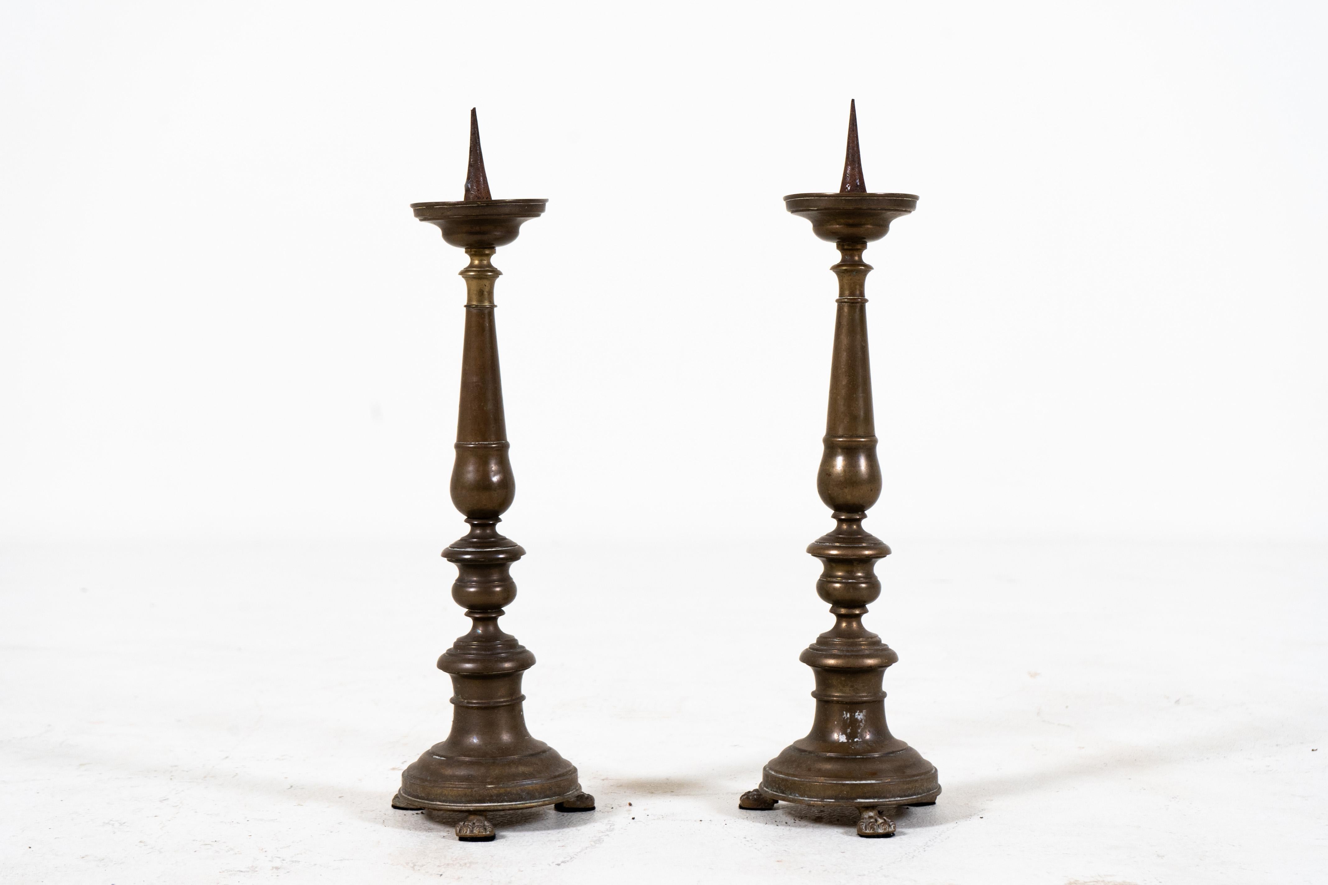 This simple and elegant set of candleholders was found in the south of France, near Avignon. The surface patina, once polished, has grown muted and flat due to exposure and use. The candle socket can accept wax candles up to 3
