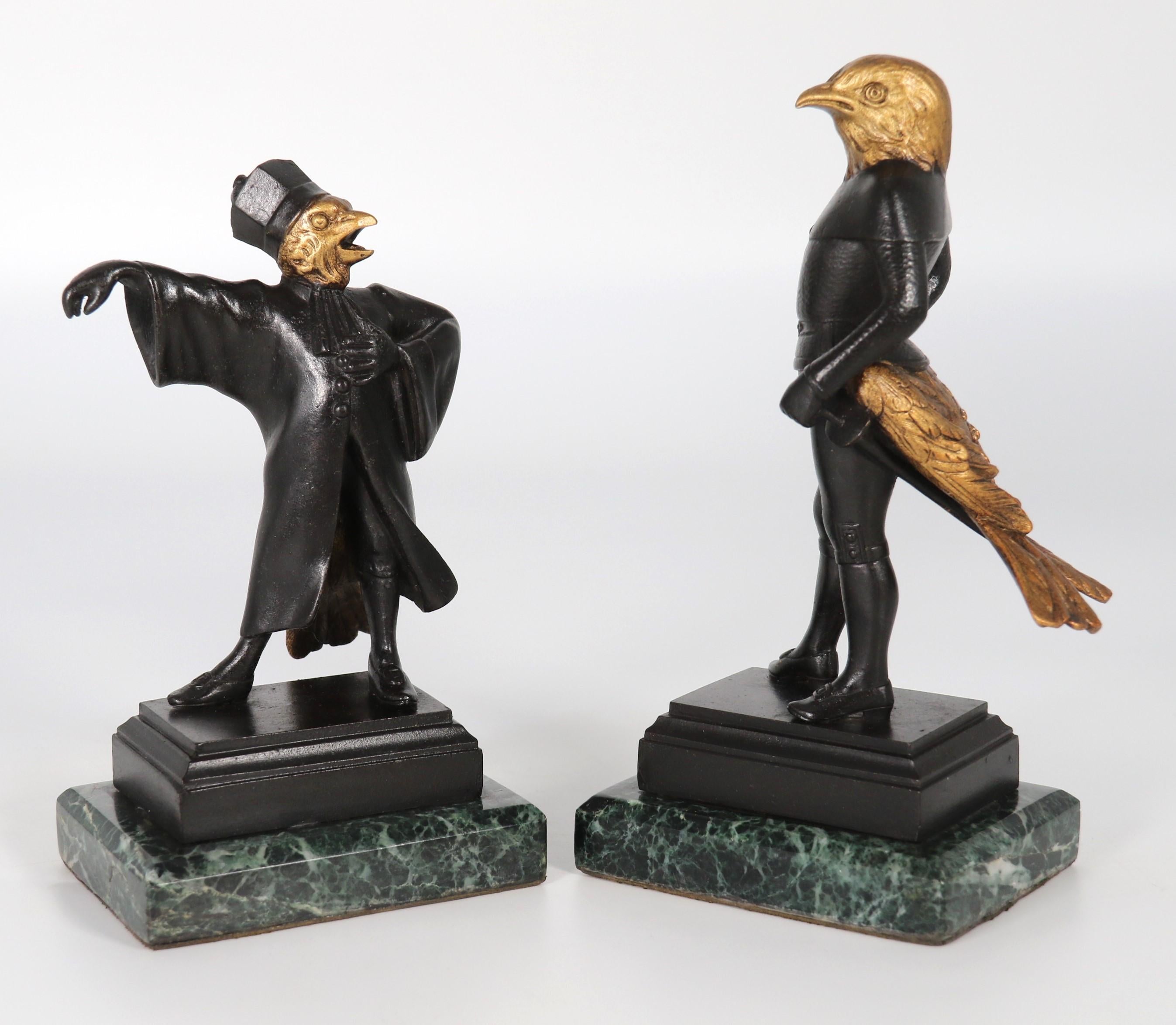 A most unusual pair of late 19th century bronze figures depicting caricatures of a jackdaw and crow, each with human bodies including torso, legs and arms,  and tail feathers with a bird head, each figure is dressed in theatrical costume whilst