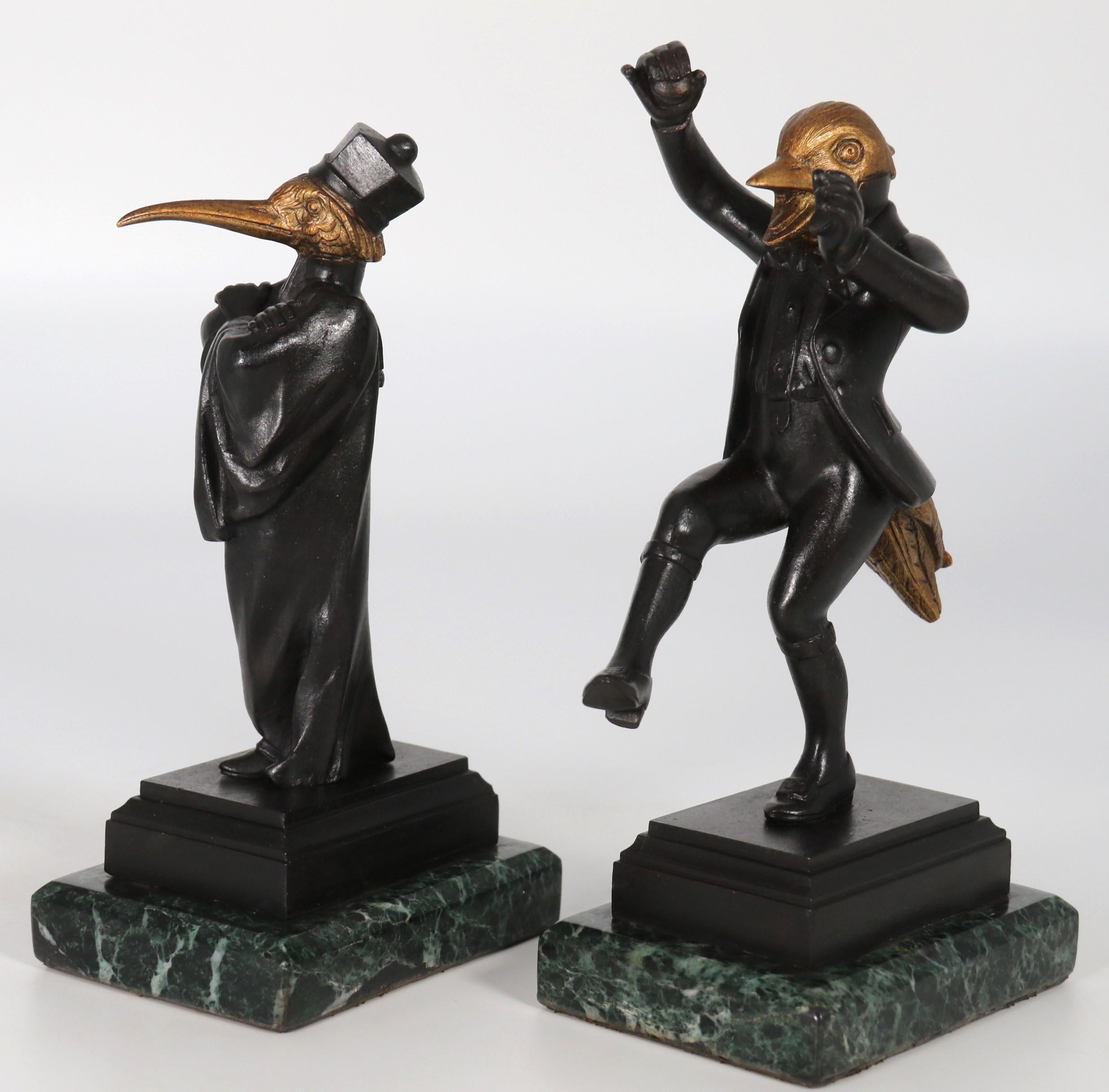 A most unusual pair of late 19th century bronze figures depicting caricatures of a heron and mallard duck, each with human bodies including torso, legs and arms,  and tail feathers with a bird head, each figure is dressed in theatrical costume