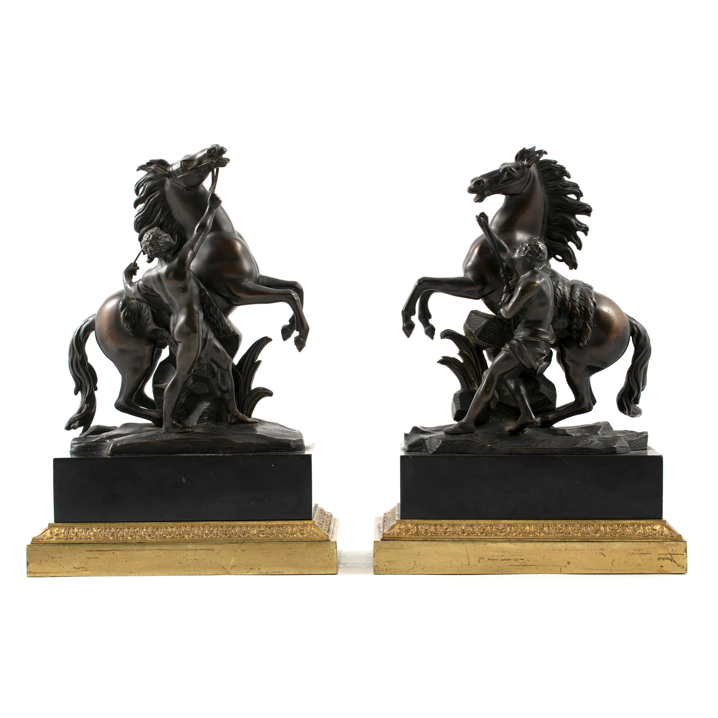 A pair of bronze Marly horses after Guillaume Coustou.
This pair of statues are known as 'horse tamers' or 'horses restrained by grooms'. Each of a rearing horses restrained by a semi clad male attendant.

France 1860-1870. Napoleon III. In