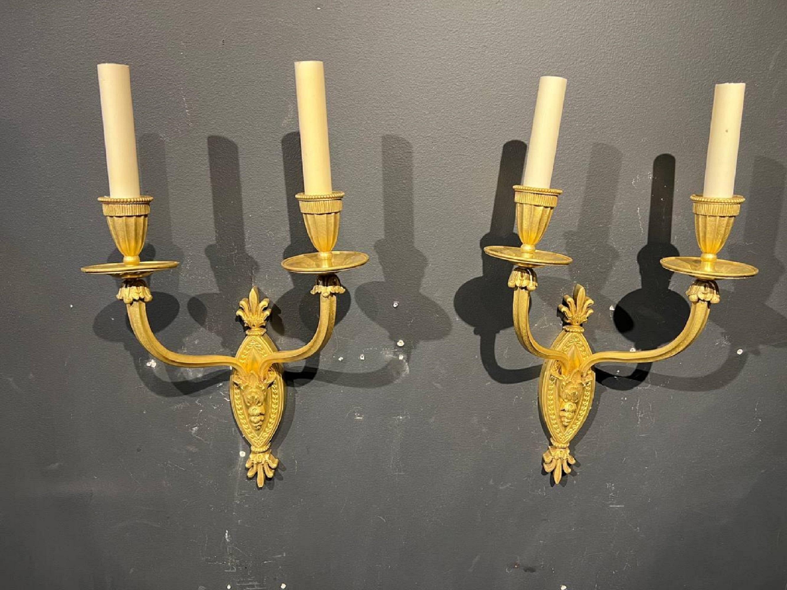 A pair of 1920s French gilt bronze double light sconces.

Dealer: G302YP.