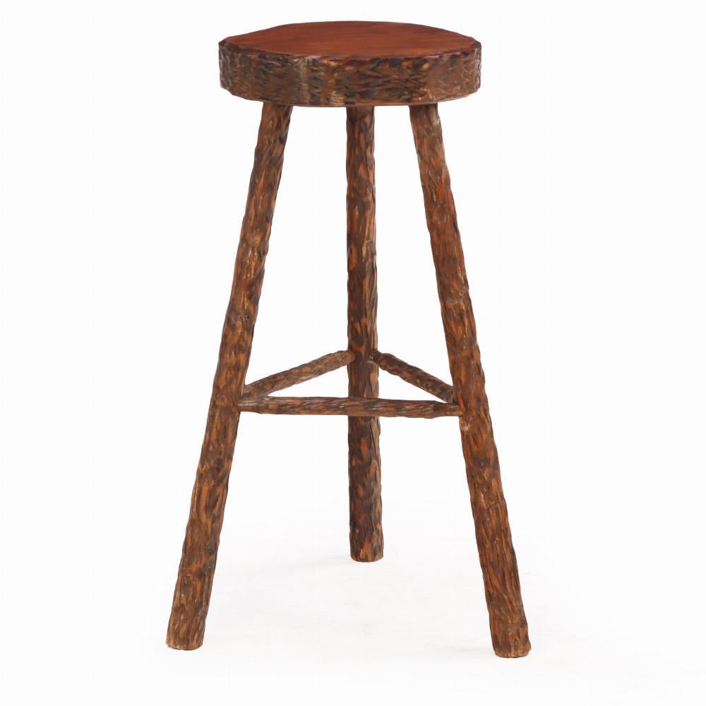 Each stool features a thick, round seat with deep gouge-carved detailing, showcasing expressive handwork and raw materiality. Each supported by three turned legs joined by robust stretchers, the stools exhibit a bold, primitive aesthetic