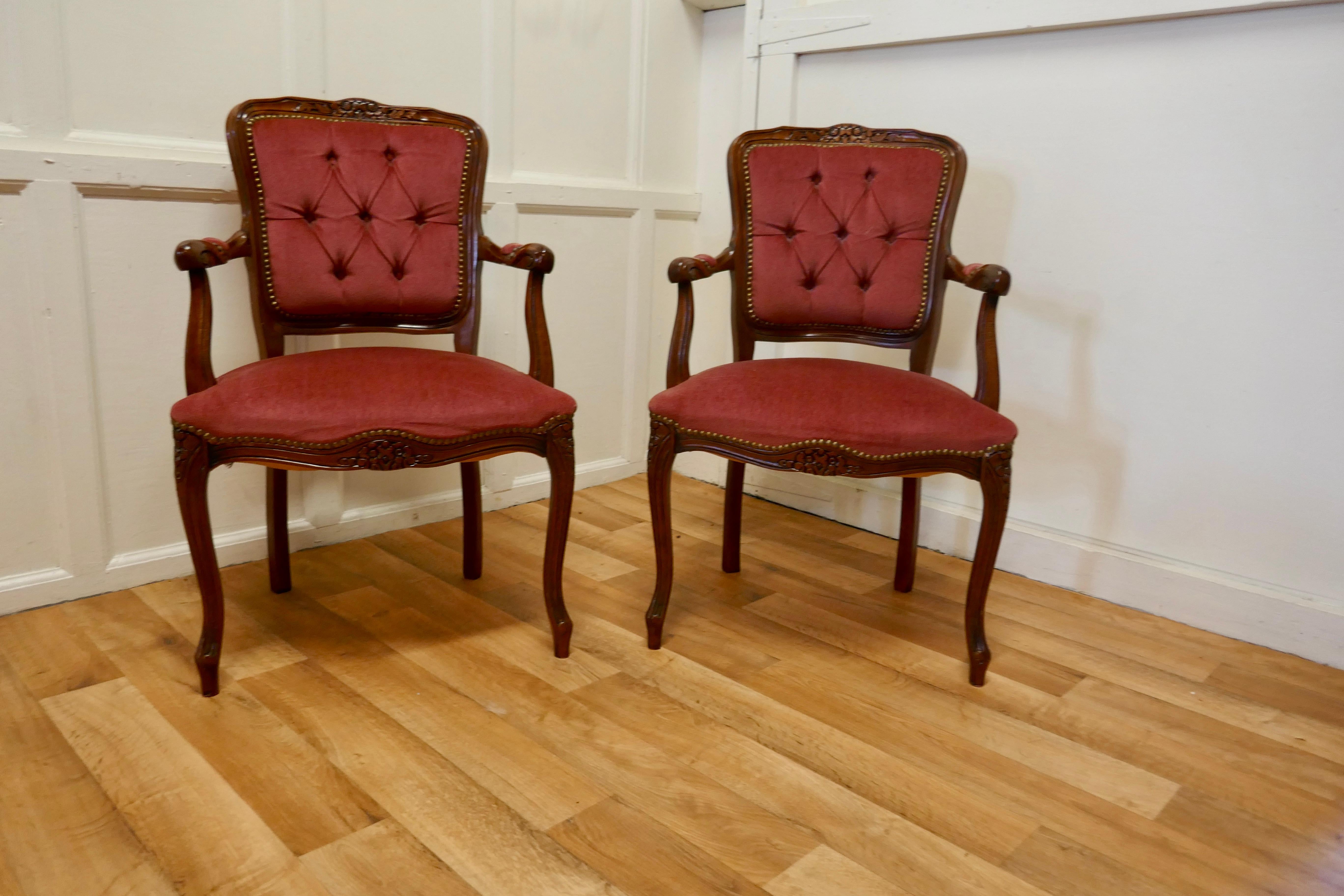 A Pair of French Button Back Salon Chairs 

These beautiful chairs are wide and very comfortable, they are upholstered with Draylon in a slightly muted shade of dark cherry 
The beech show wood on the back, legs and front of the chairs is carved