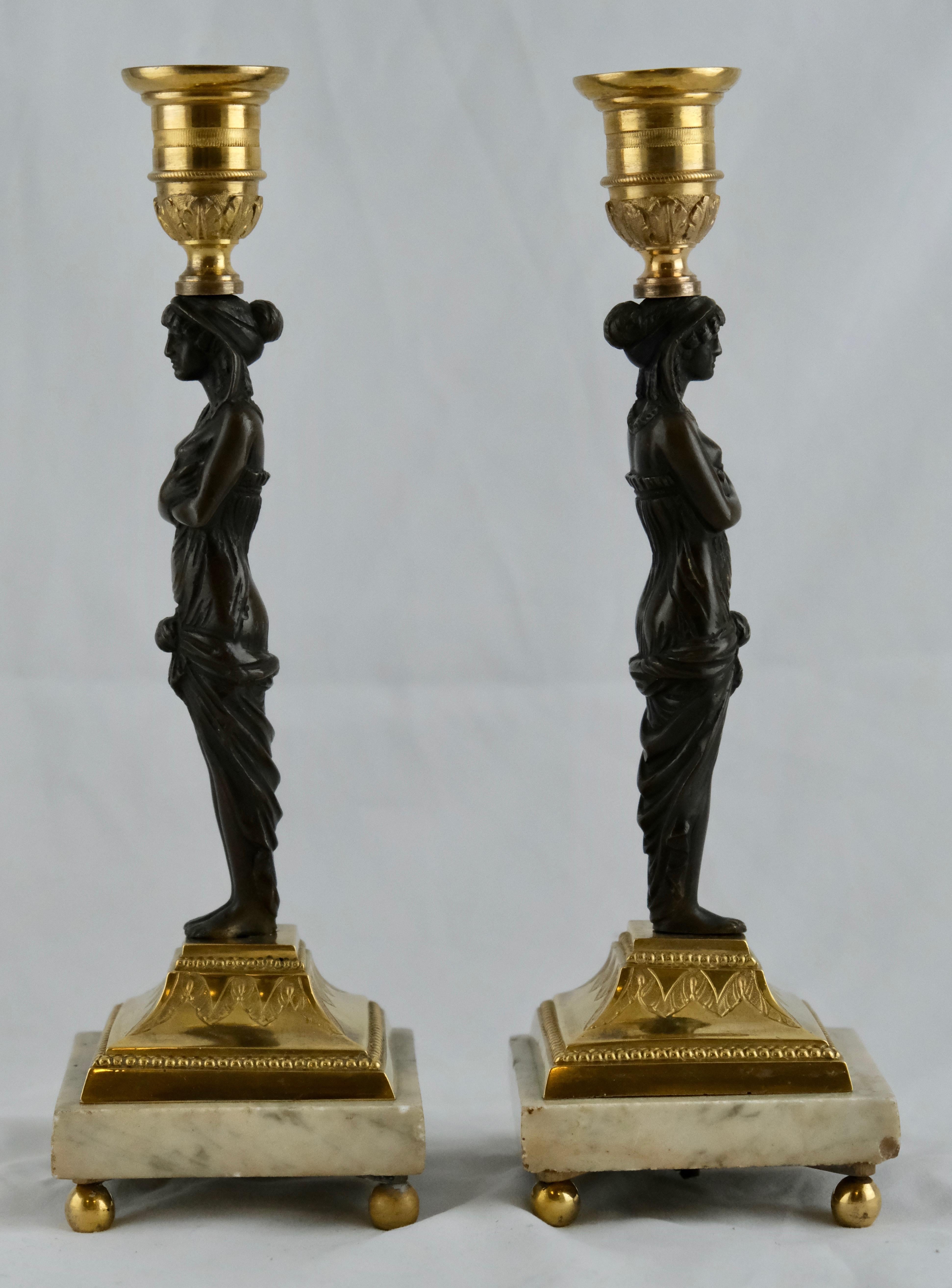 A classical pair of candlesticks made of marble, gilt and blackpatinated bronce. Nicely done and good quality. They would fit any dinnertable or wherever you want to put them.