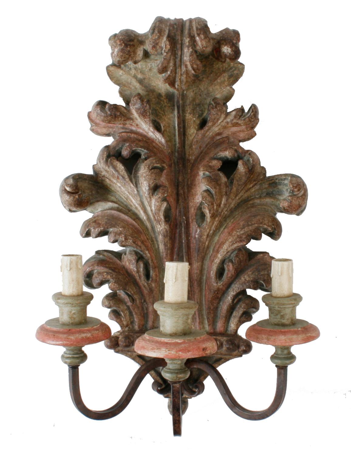 A pair of French carved and painted Acanthus leaf three light wall sconces. Each sconce has a beautiful patinated paint finish with three metal arms holding antiqued mauve bobeche, sage green candle holders, and ivory candle sleeves. The sconces are