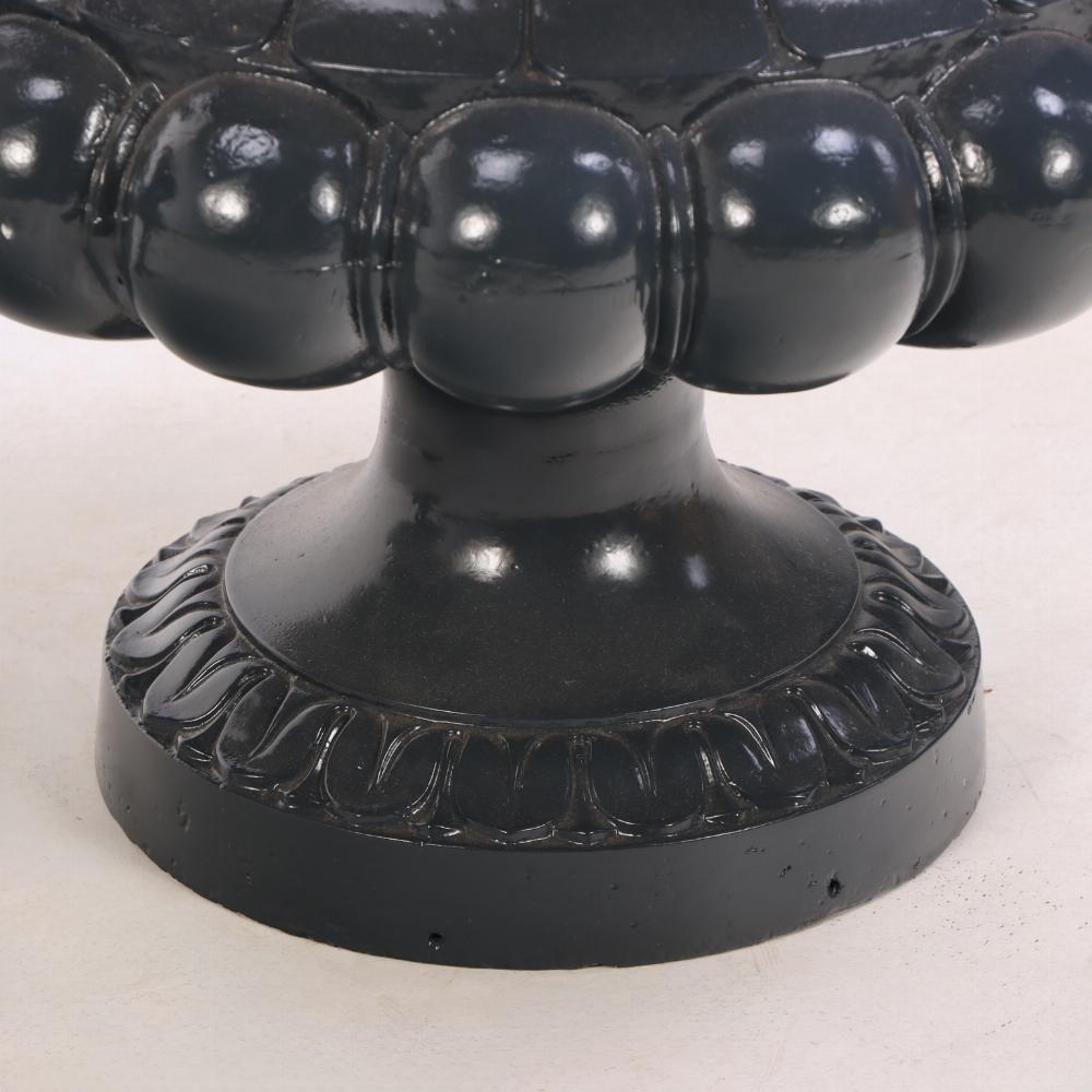 These 19th-century French cast iron garden urns are a classic with scrolled side handles and a flared lip over a bulbous footed circular base. Recently sandblasted and professionally painted, the urns have been carefully restored to preserve their