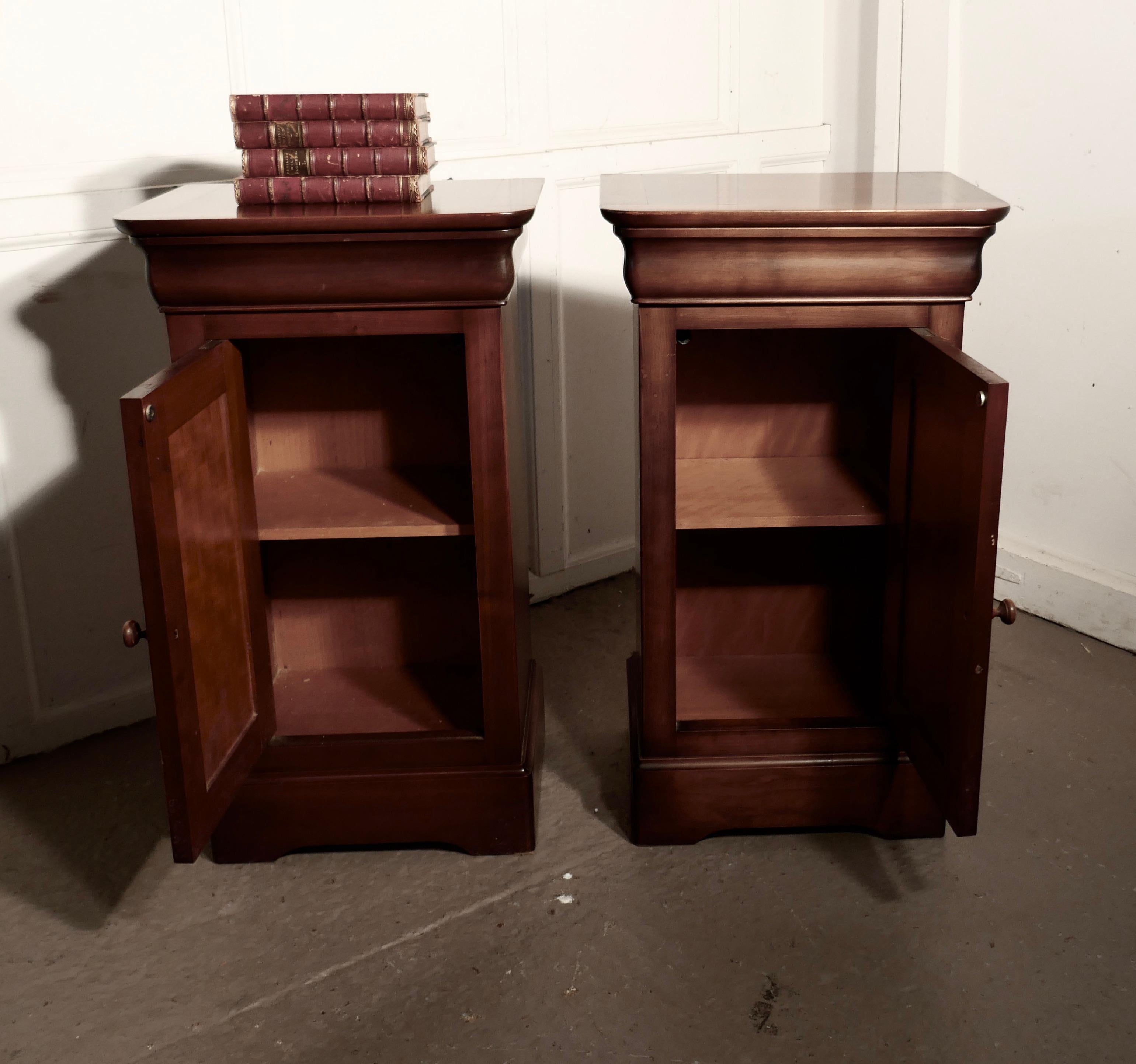 A pair of French cherrywood bedside cupboards or night tables

These are very attractive pieces they are made in well figured cherry, they each have a panelled Door to the front with a concealed drawer over, there is a shelf inside, and they stand