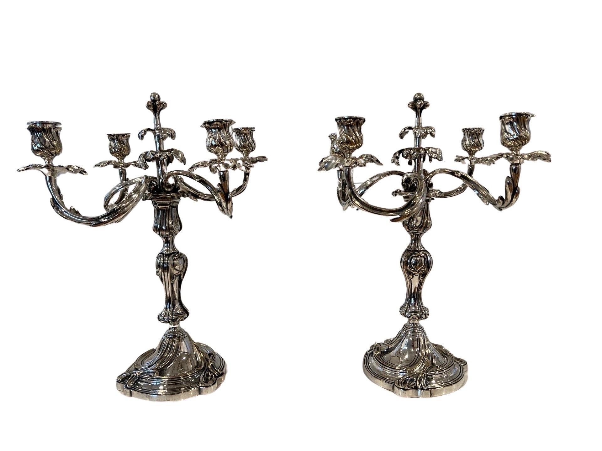 Christofle (French, founded 1830), L 20th century.

Each silver plate candelabrum with a convertible candlestick column with knopped stem on a swirled rocaille base issuing five radial spiral arms, each terminating in a foliate-style capital and