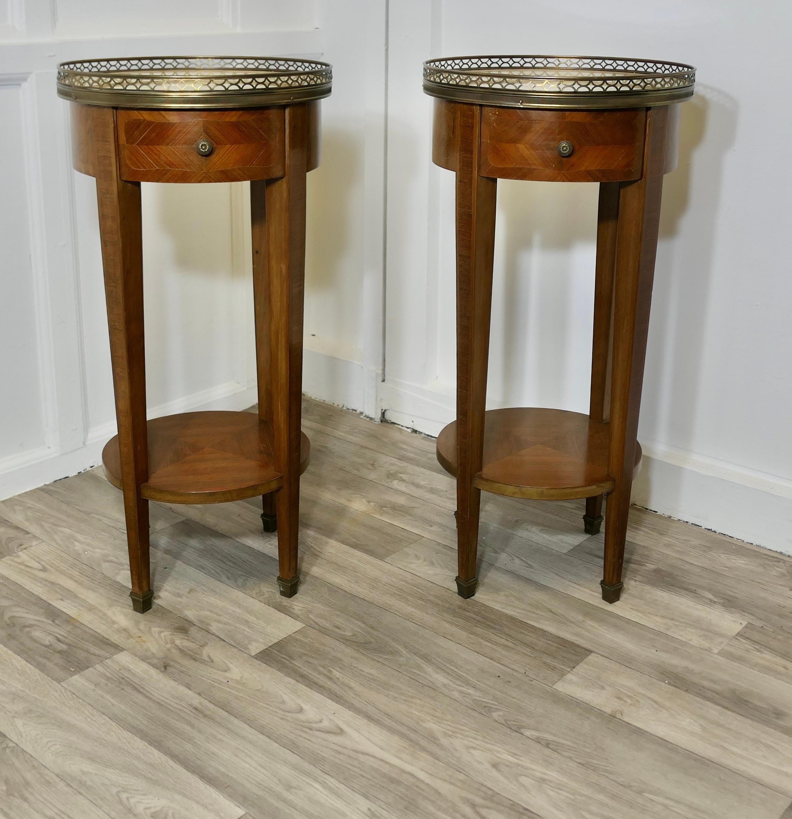 A Pair of French Circular Side Tables with Drawers 

This is a superb quality pair of French side tables they are a circular shape  with marble tops and a pierced brass gallery around, they each have a drawer to the front
The tables are made in