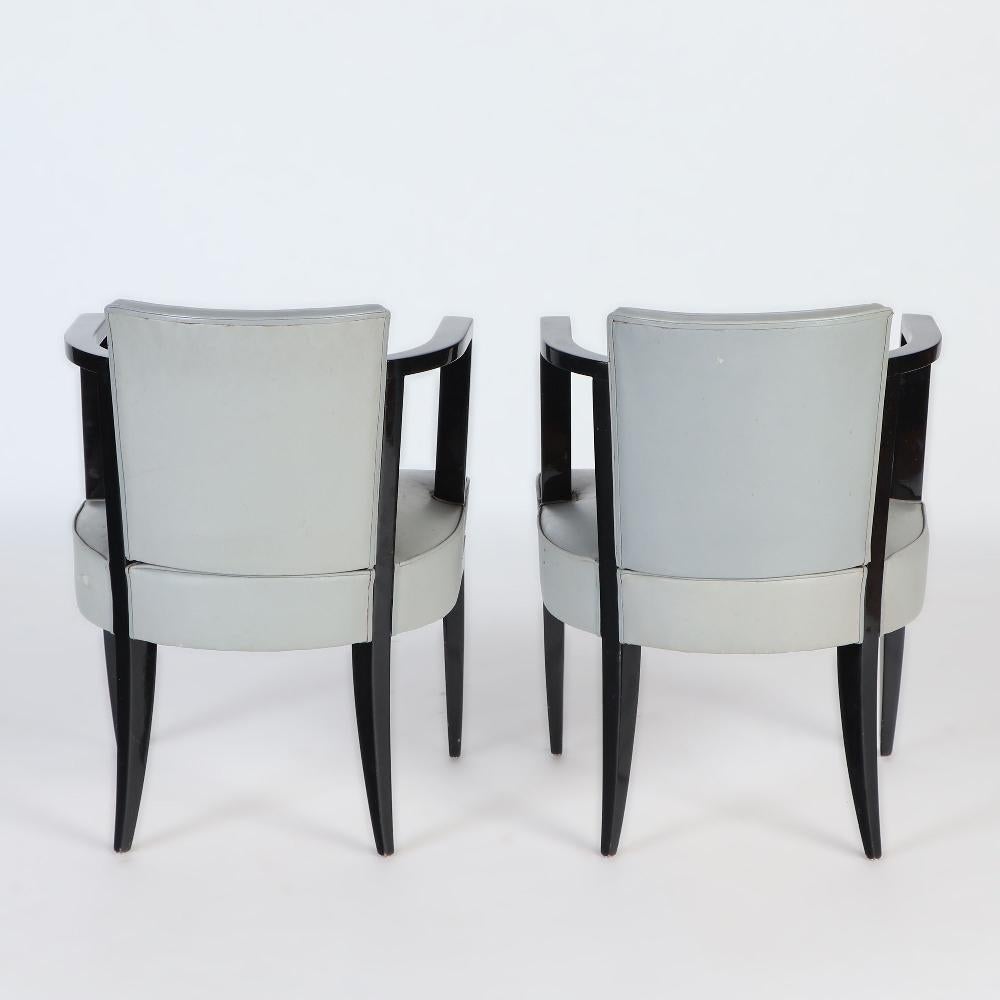 Mid-20th Century A Pair of French ebonized open armchairs with faux leather upholstery. C 1940 For Sale