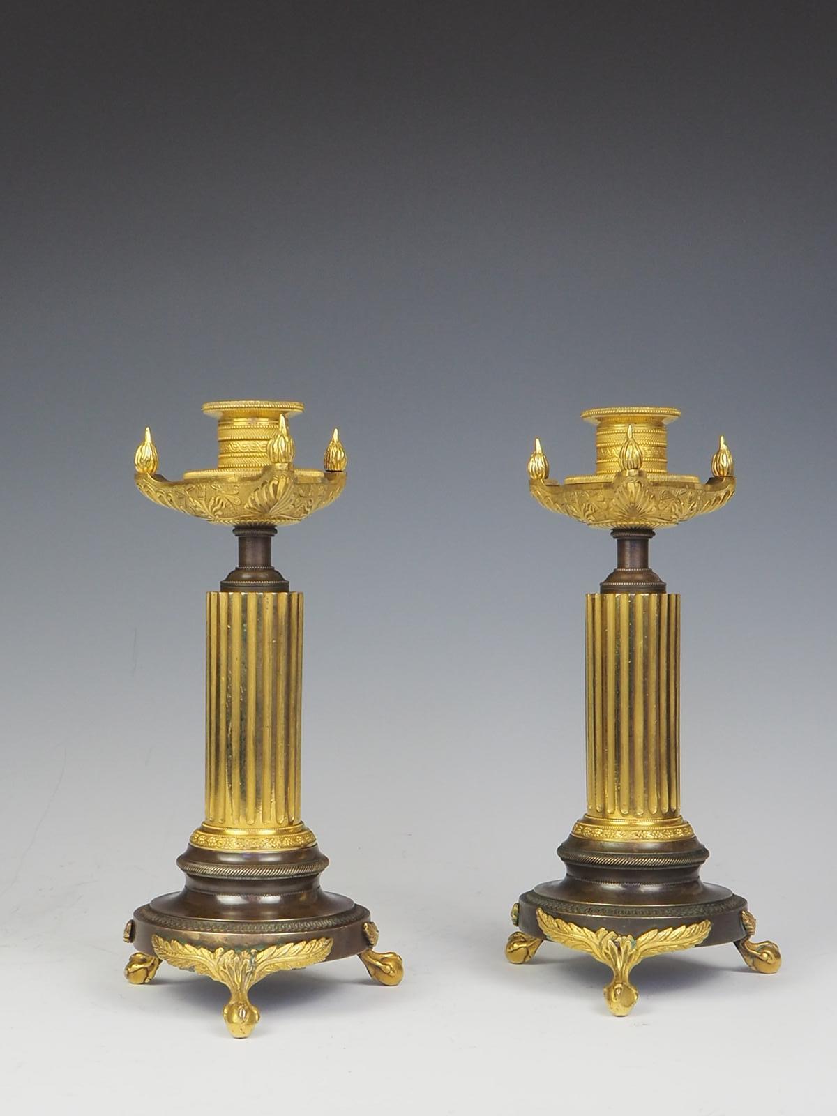 A Pair of French Empire Bronze and Ormolu Candle Holders, circa 1820.

Nozzles within classical style oil lamp platform and flambeaux.

Provenance: Christies, Interiors, 20/09/11, lot 246.