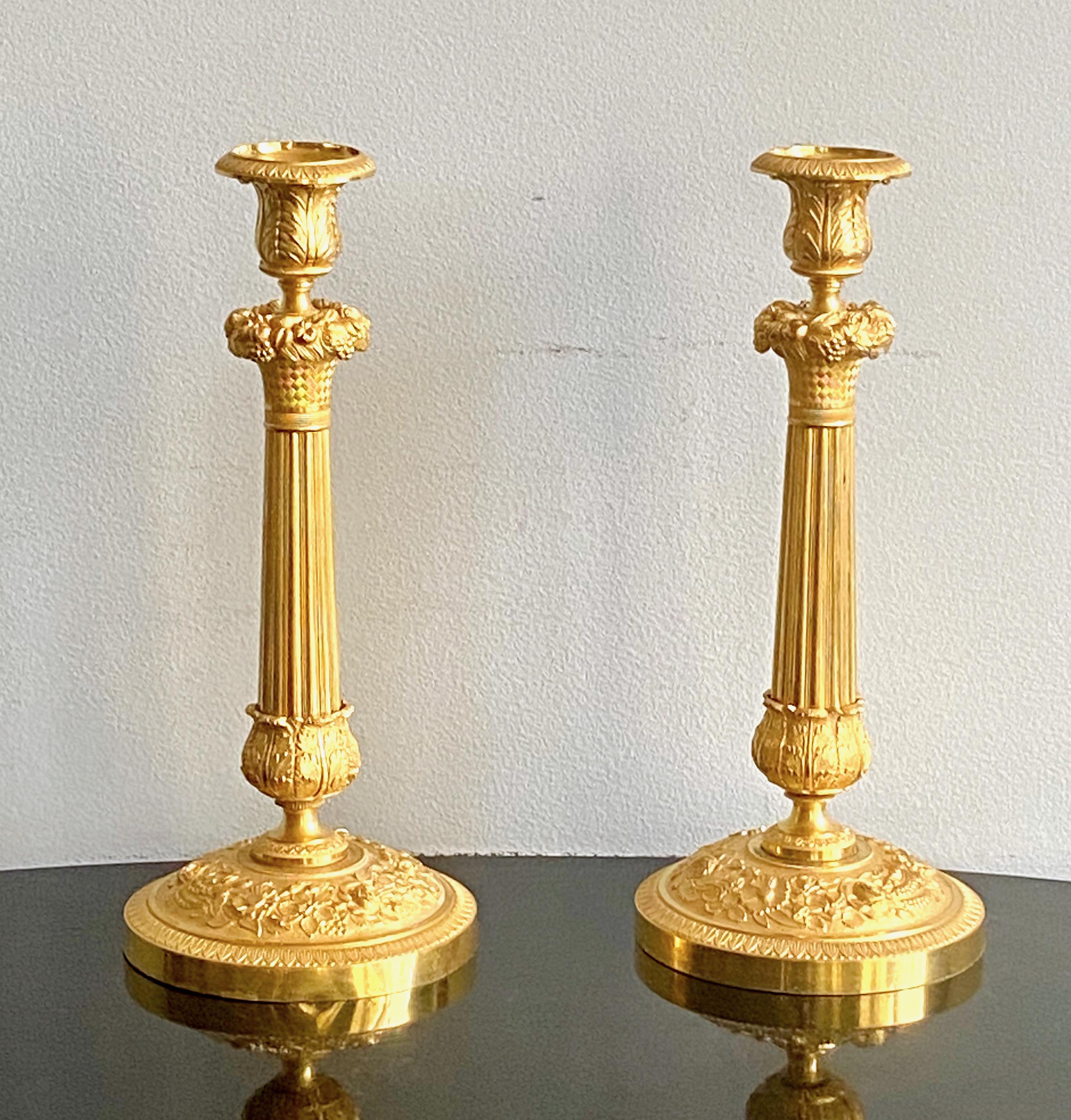 A fine pair of French empire gilt bronze candlesticks, Ca 1820-30.