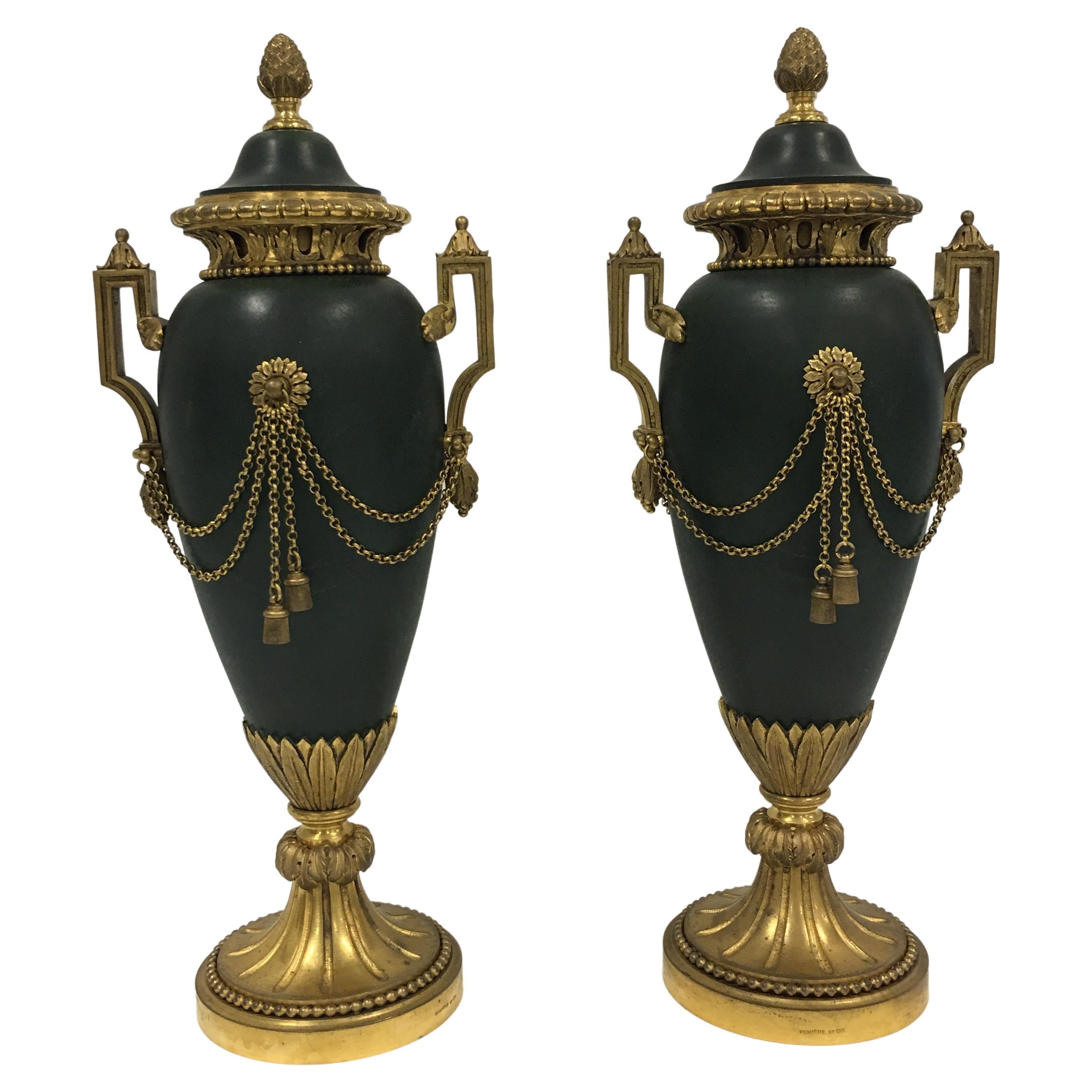 A pair of French Empire period painted bronze and ormolu casolettes