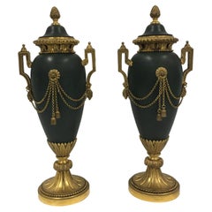 A pair of French Empire period painted bronze and ormolu casolettes