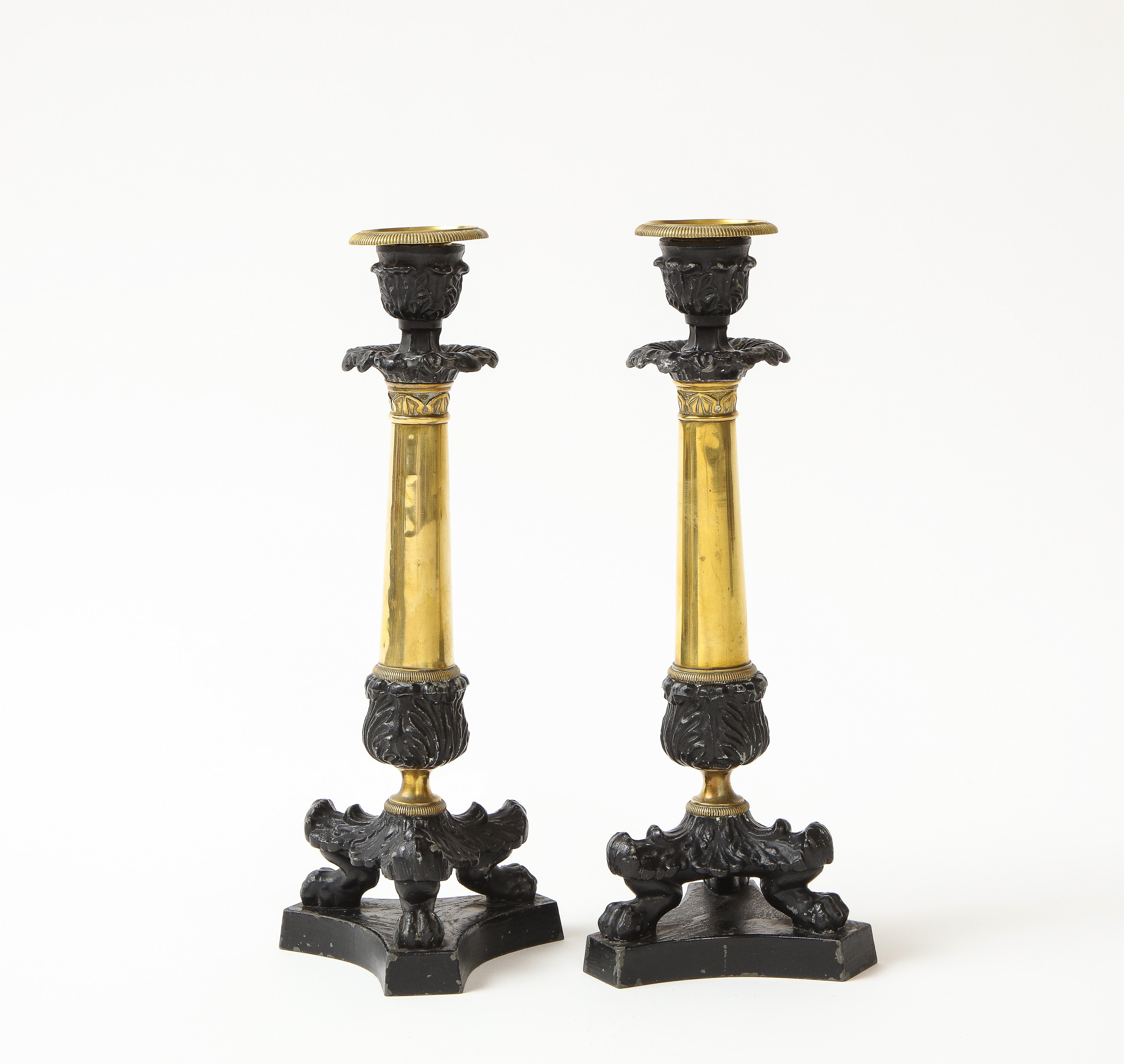 Each with removable nozzle in brass above an acanthus shoulders over a brass column with lotus-leaf capital terminating in an acanthus-form knob, supported on a tripartite base with acanthus-enriched claw feet.