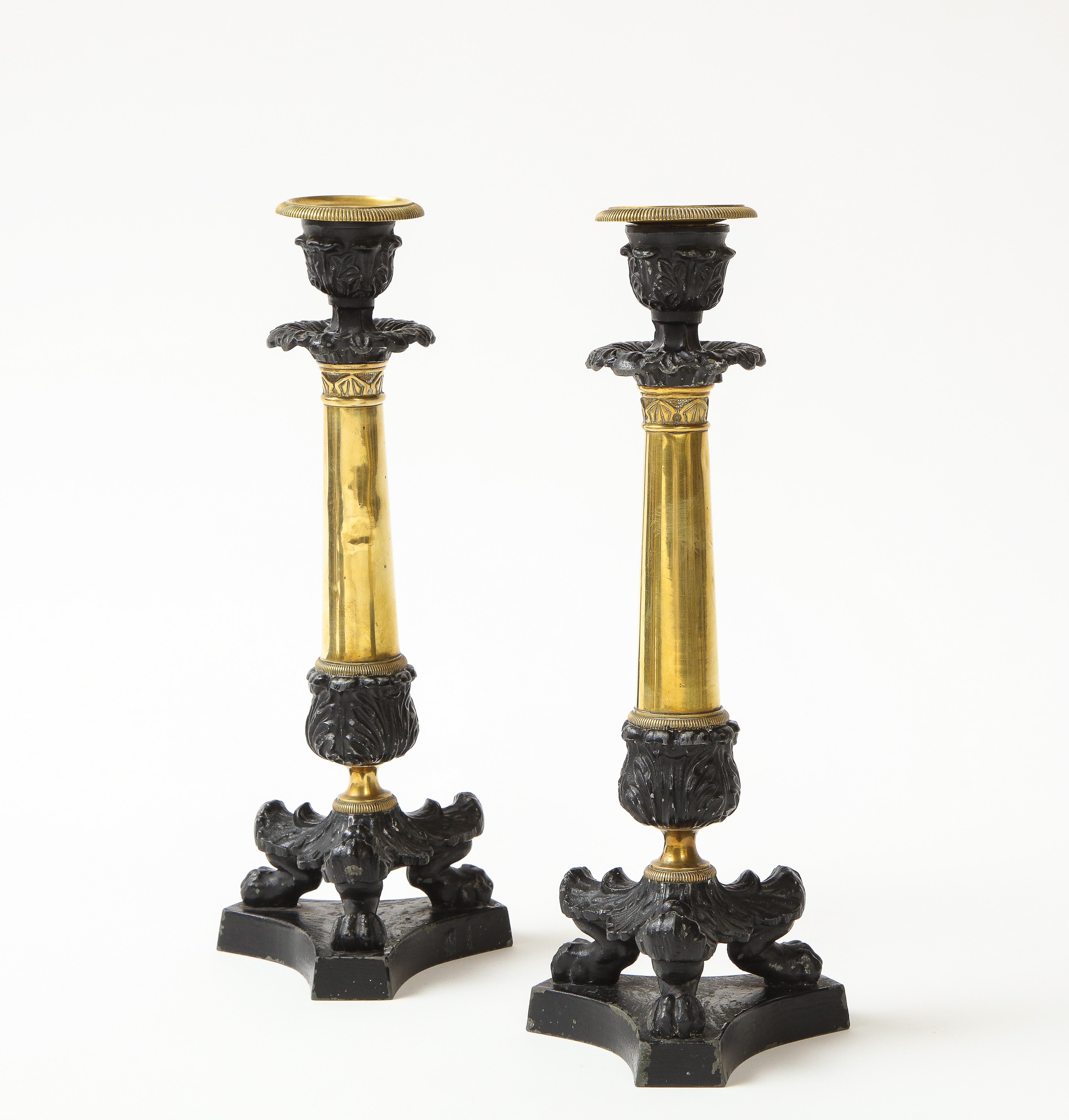 Early 19th Century Pair of French Empire Polished Brass and Black-Enameled Cast Iron Candlesticks For Sale