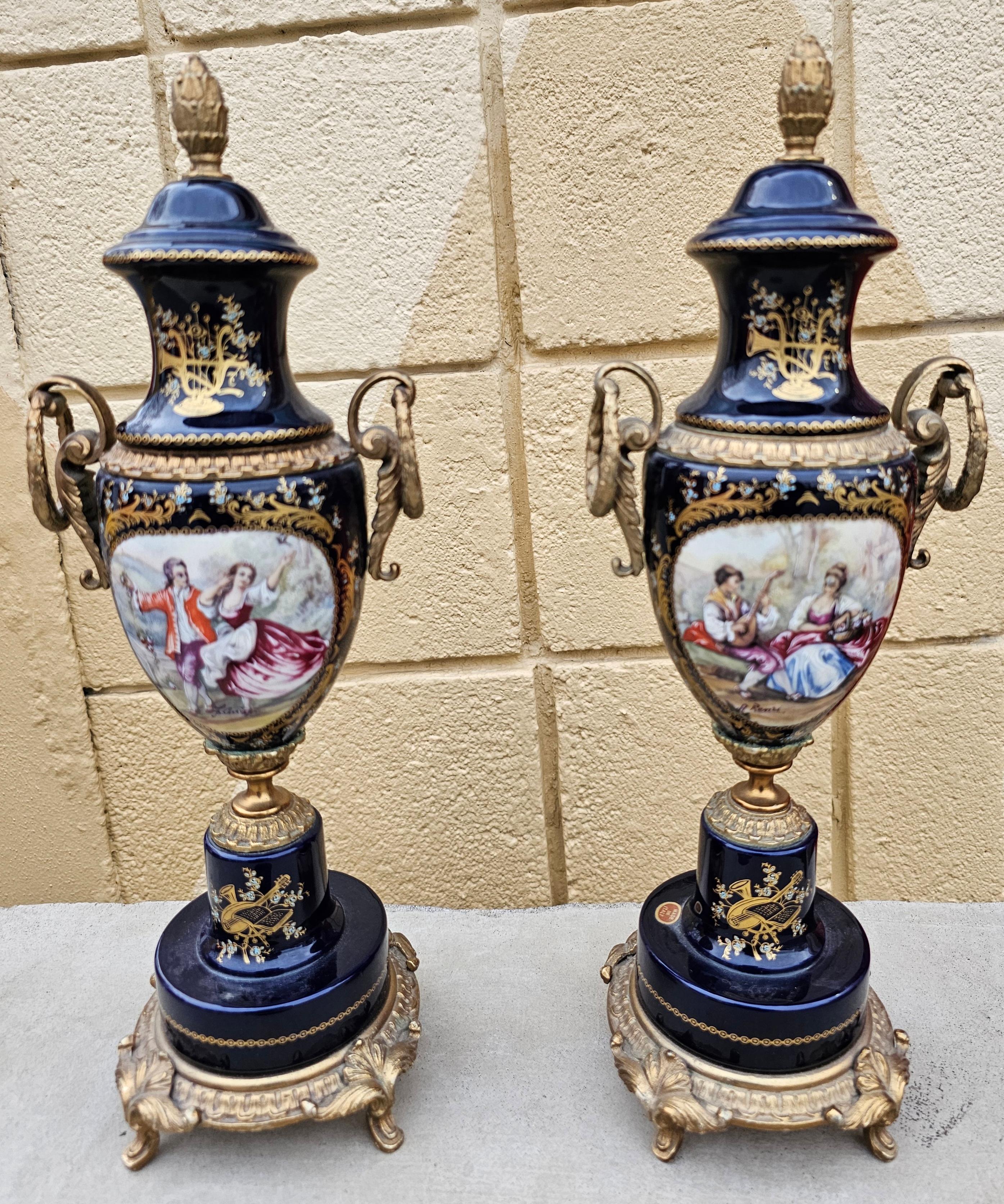 A Pair of  Italian Made French Empire Louis XV Sèvres Porcelain Gilt Bronze and Transfer hand decorated integrated Covered Urns. Very good condition. Measures 5