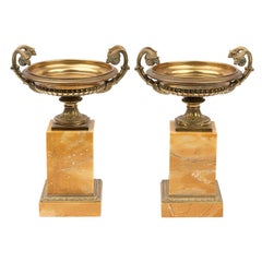 A Pair of French Empire Style Gilt bronze Urns on Marble Stands, 20th Century
