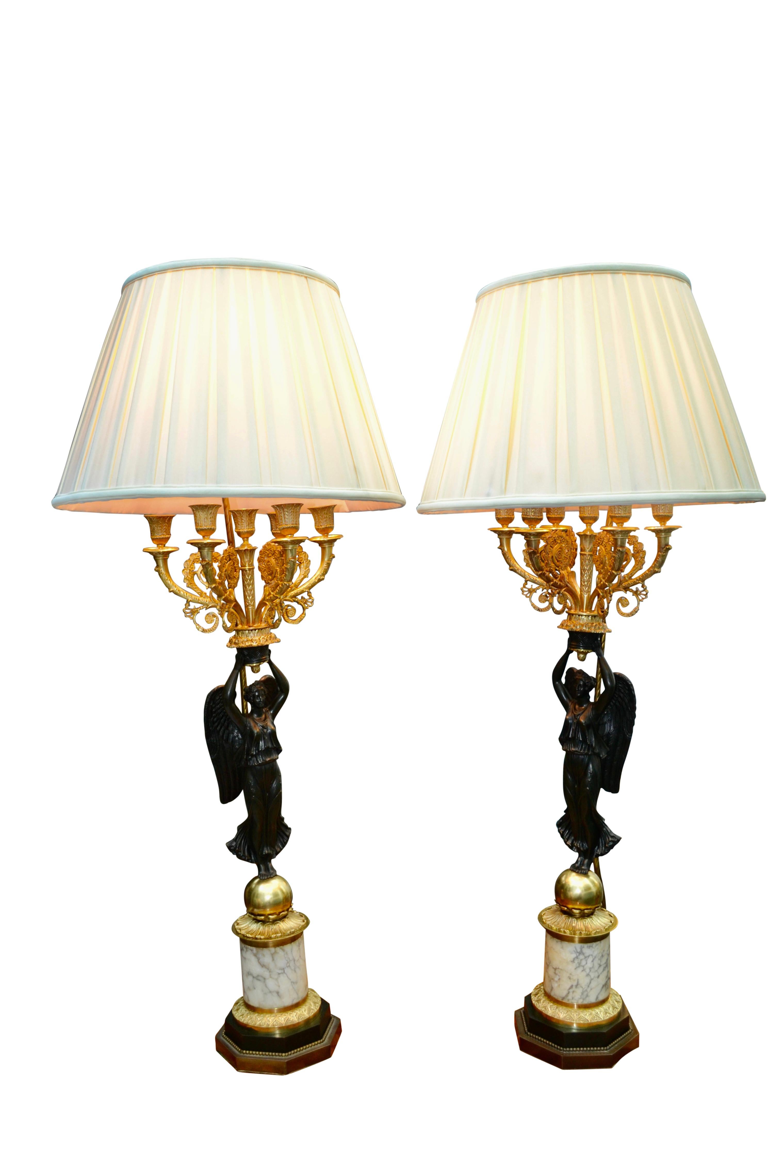 Hand-Carved A Pair of French Empire Style Patinated and Gilt Bronze Winged Victory Lamps For Sale